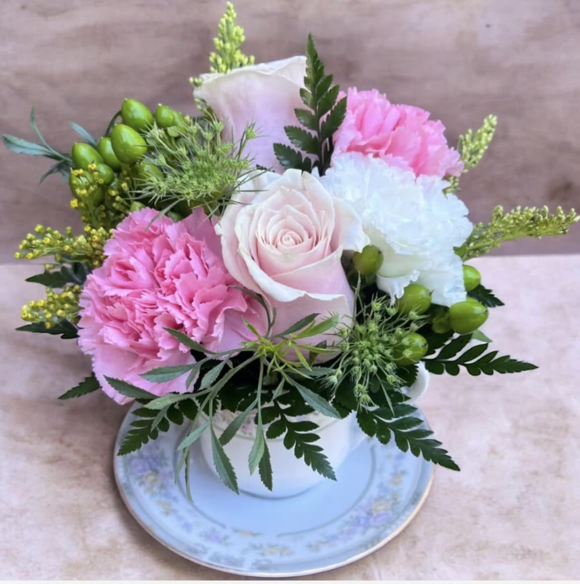 Pink Lemonade Tea Cup  - This arrangement has roses, hypericum, solidago, queen Ann’s lace, carnations and greenery. 