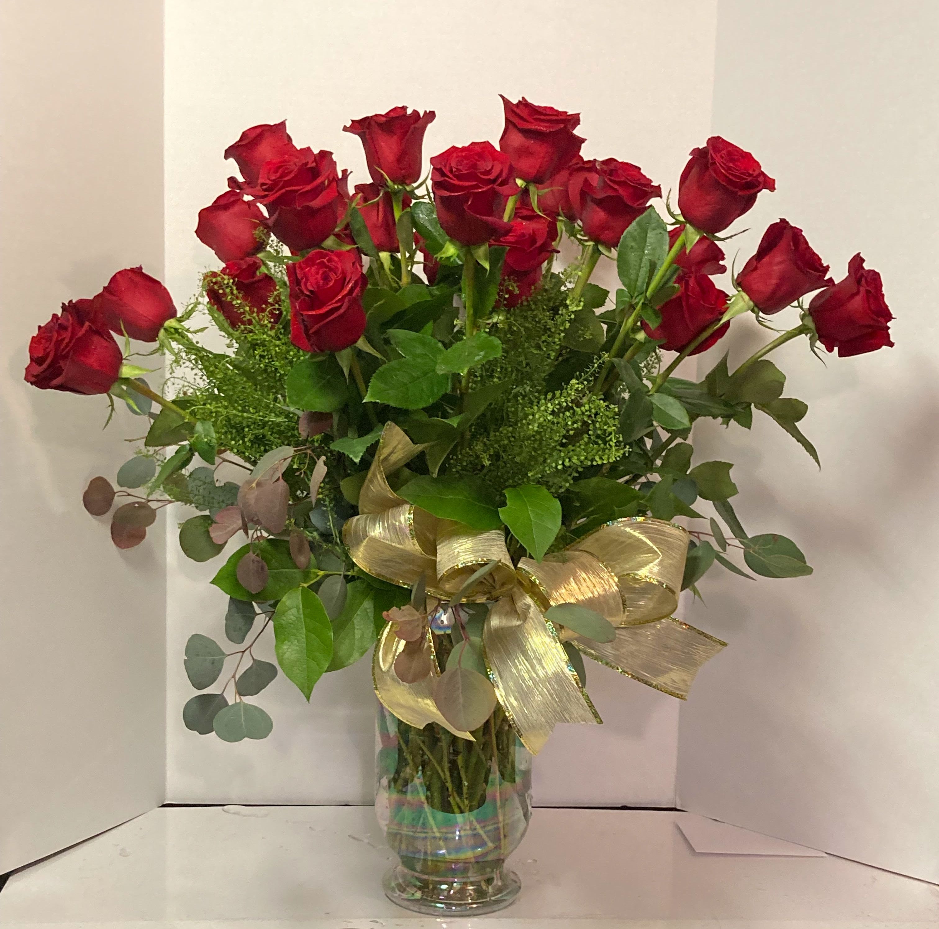 24 KARAT 60 CM - 24 RED ROSES, WITH GREENS &amp; FILLER FLOWERS. ARRANGED IN A CUSTOM VASE.