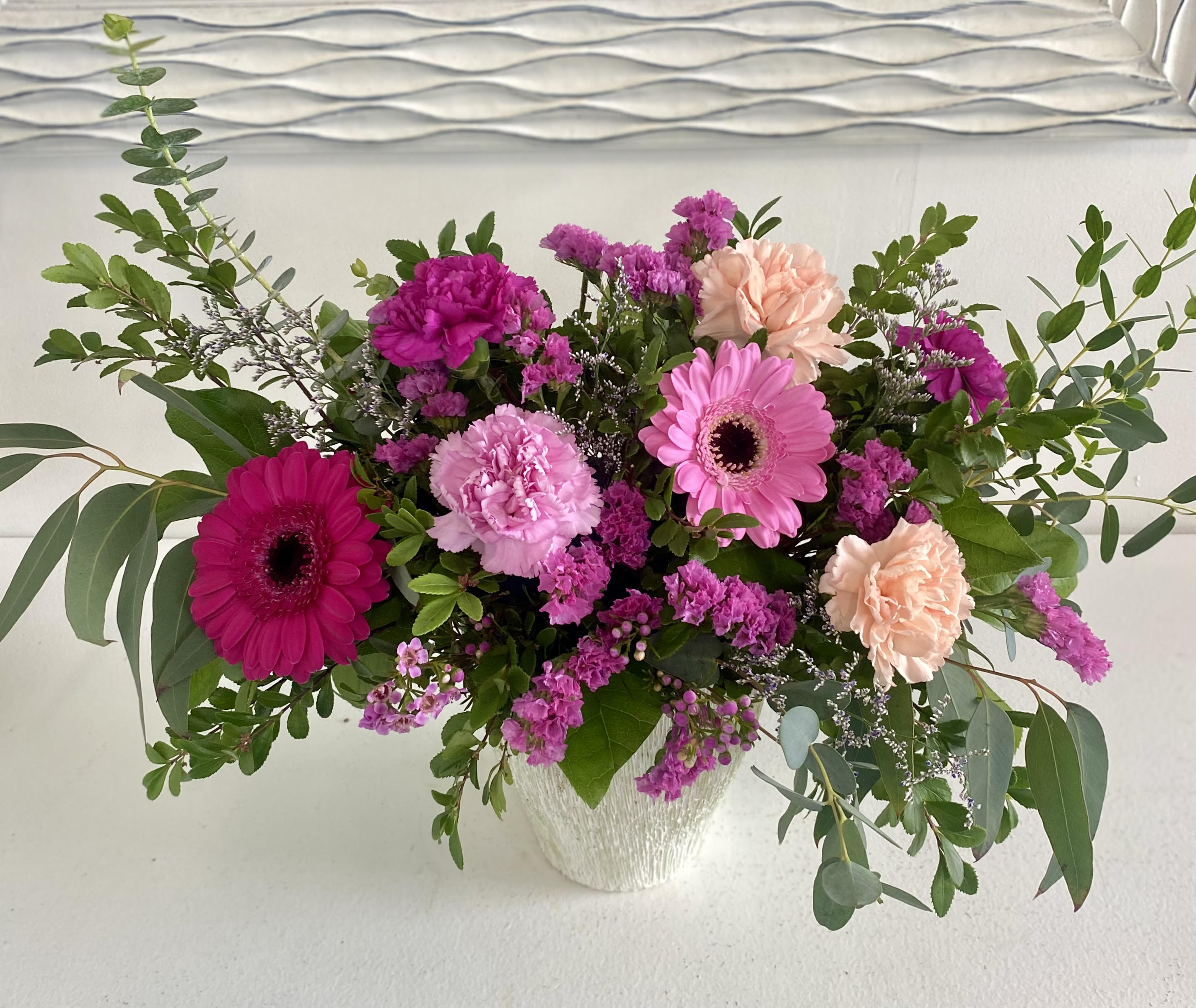 Strawberry Cream - A burst of beautiful pink hues, this vibrant arrangement features striking magenta gerbera daisies, soft pink carnations, and delicate lavender accents. Lush greenery, including eucalyptus and fragrant sprigs, adds an elegant touch. Perfect for brightening up any space or celebrating a special occasion, this bouquet radiates warmth and charm!