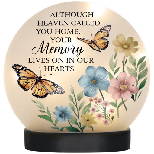 "IN OUR HEARTS" LED TABLE DECOR - "Our LED Table Décor combines artistry and ambiance with its handblown glass design, durable resin base, and glowing LED string lights. Featuring an easy ON/OFF switch and powered by 3 included LR44 batteries, this piece brings a warm, inviting touch to any room or tabletop display."  W: 8" H: 8 " DIA: 5 1/8"