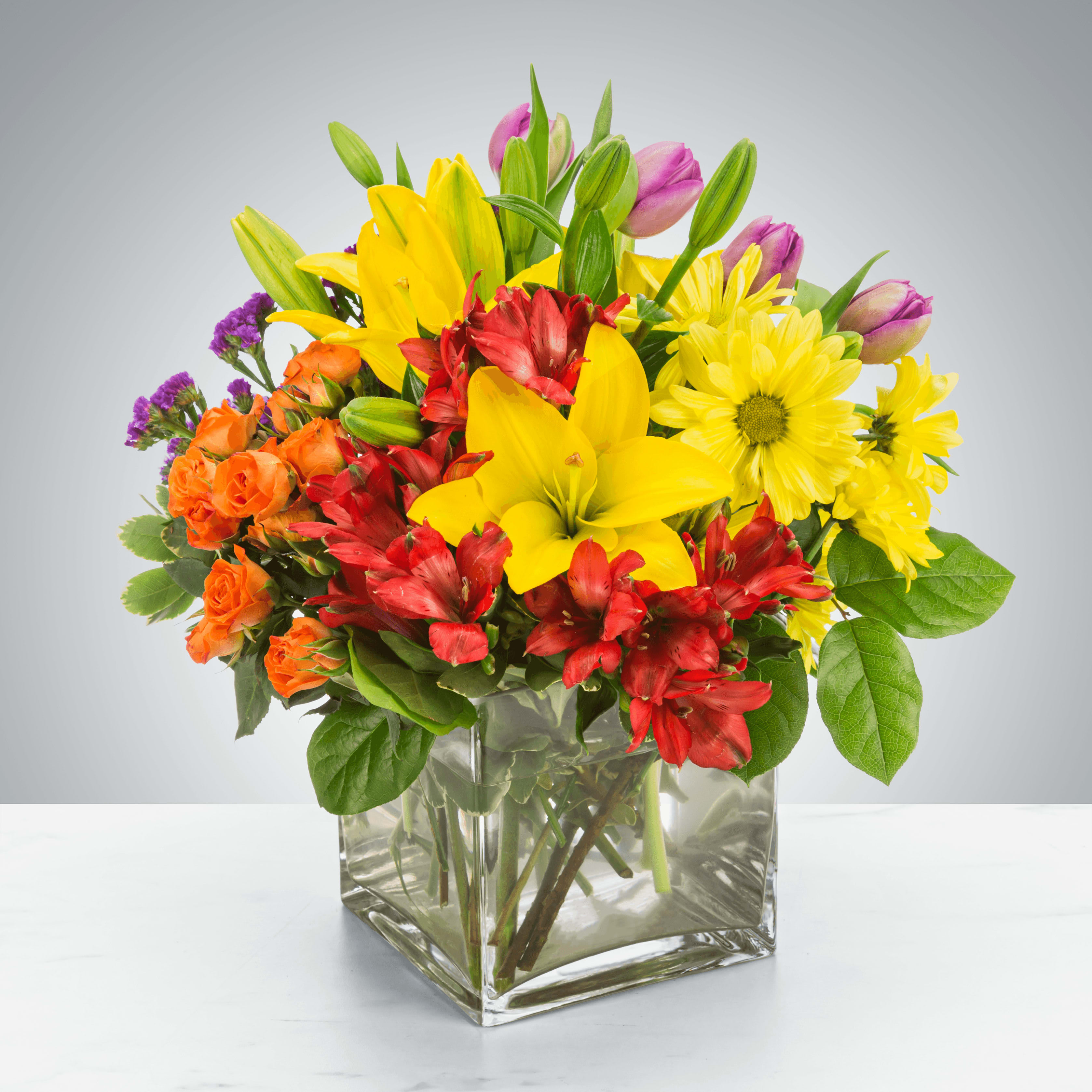 Juicy by BloomNation™ - Juicy by BloomNation™ packs a color punch! Featuring over 6 different flowers and greens, all in different colors, this arrangement is a great option for sending to co-workers, friends, or clients. Make a brightly colored splash .For same day delivery and Free Delivery Options Text or Call  832-973-1376.  Approximate Dimensions: 11"D x 11"H