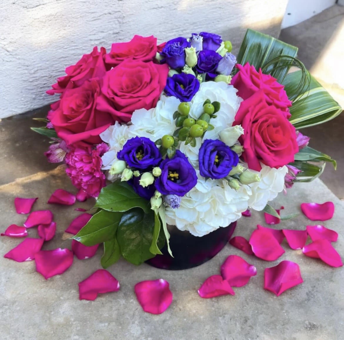 Deepest Desires - This beautifully designed arrangement is filled with hydrangea, roses, Lisianthus, Hypericum, aspidistra, alstroemeria, Bear grass and carnations and lemon leaf.