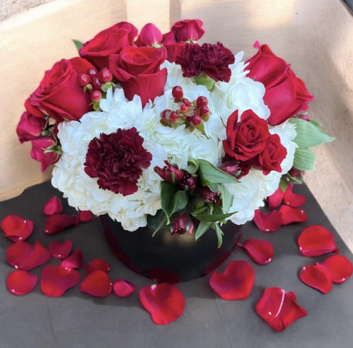 Red Velvet  - This beautifully designed arrangement is filled with hydrangeas roses, alstroemeria, spray, roses, carnations, and hypericum. 