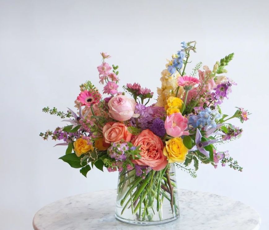 Springtime Feelings - A beautiful variety of the  best spring  has to offer. Mixture of florals in a clear glass vase