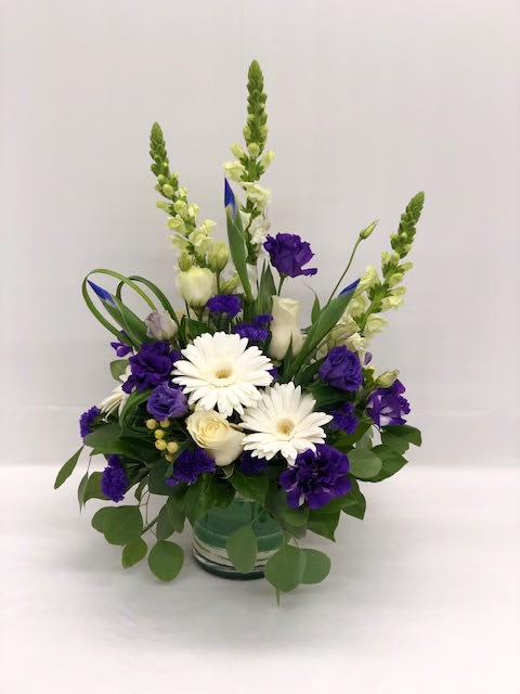 So Regal - So Regal  An elegant purple and white floral arrangement featuring gerbera daisies, lisianthus, irises, snapdragons, hypericum berries, roses, and lush seasonal greenery. Artfully arranged, this sophisticated bouquet is perfect for birthdays, anniversaries, congratulations, or simply brightening any home or office.  Available for flower delivery in Mableton, Smyrna, Austell, Marietta, and Atlanta, handcrafted with fresh, premium seasonal blooms.  Please note: flower varieties and shades may vary slightly depending on seasonal availability, making each arrangement unique.
