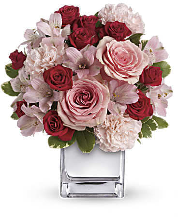 Love That Pink Bouquet with Roses - "Luscious" is the word to describe this gorgeous bouquet of red and pink roses and other romantic favorites in a chic mirrored silver cube. It's simple and simply spectacular. Many Valentine kisses are in order. This exquisite bouquet includes pink roses, red spray roses, pink alstroemeria and pink carnations accented with assorted greenery. Delivered in a mirrored silver cube. Orientation: All-Around