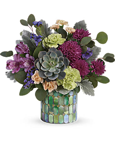Marvelous Mosaic Bouquet - When only marvelous will do! Make a stylish statement with this unique bouquet of jewel toned blooms and succulents, artfully arranged in a stained glass inspired mosaic glass cylinder. Purple alstroemeria, green carnations, peach miniature carnations, purple cushion spray chrysanthemums, and purple sinuata statice are arranged with silver dollar eucalyptus, dusty miller, and a large green echeveria succulent. Delivered in a Marvelous Mosaic cylinder. Orientation: All-Around 