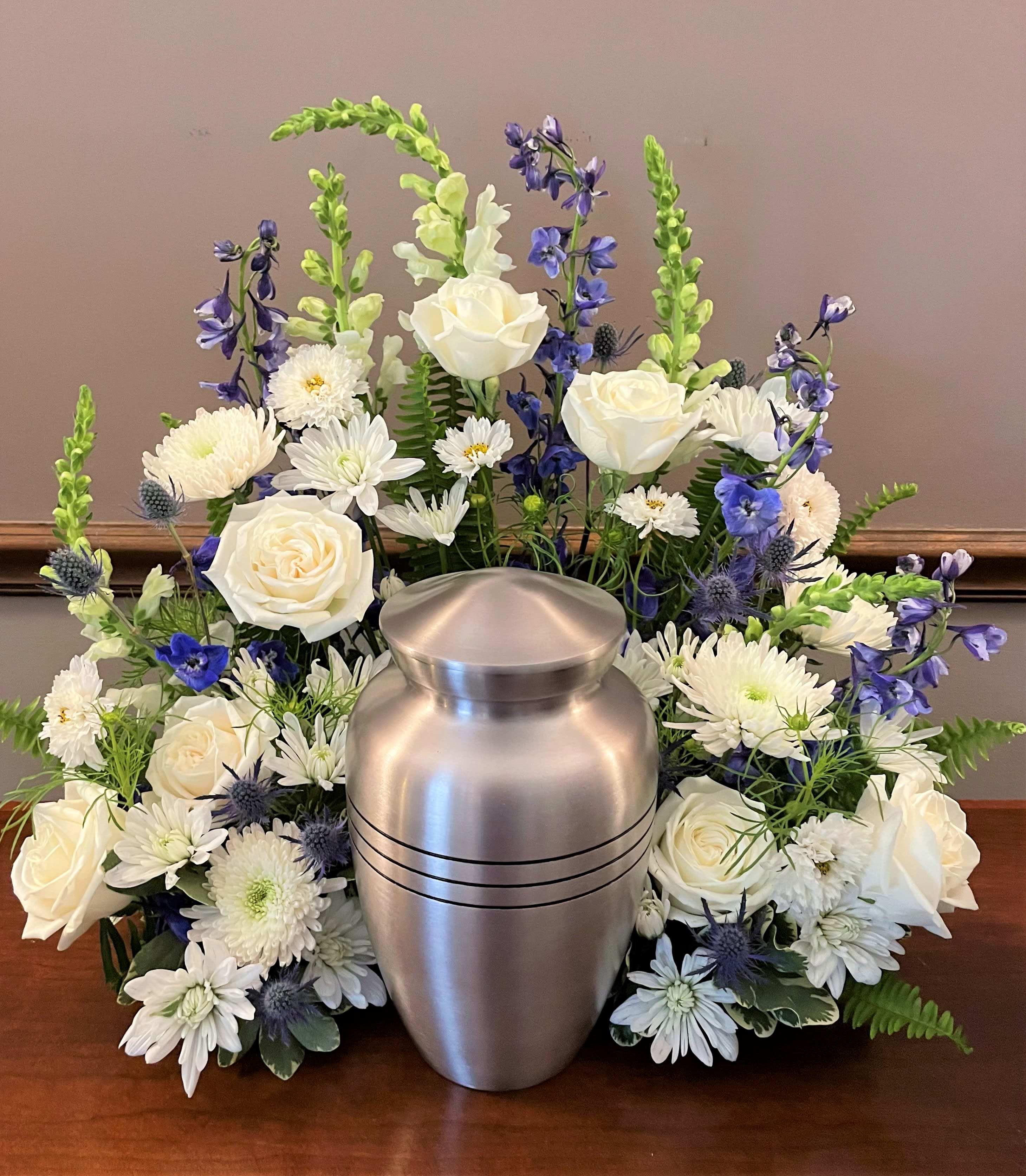 Memorial Urn Arrangement - Pay tribute to your loved one with a beautiful floral presentation to accent your loved one's urn or photo. We can customize the flowers to suit the urn you selected as well as to represent the personality of your loved one who has passed away. Upgrade includes additional compote arrangement designed to compliment the urn flowers. 