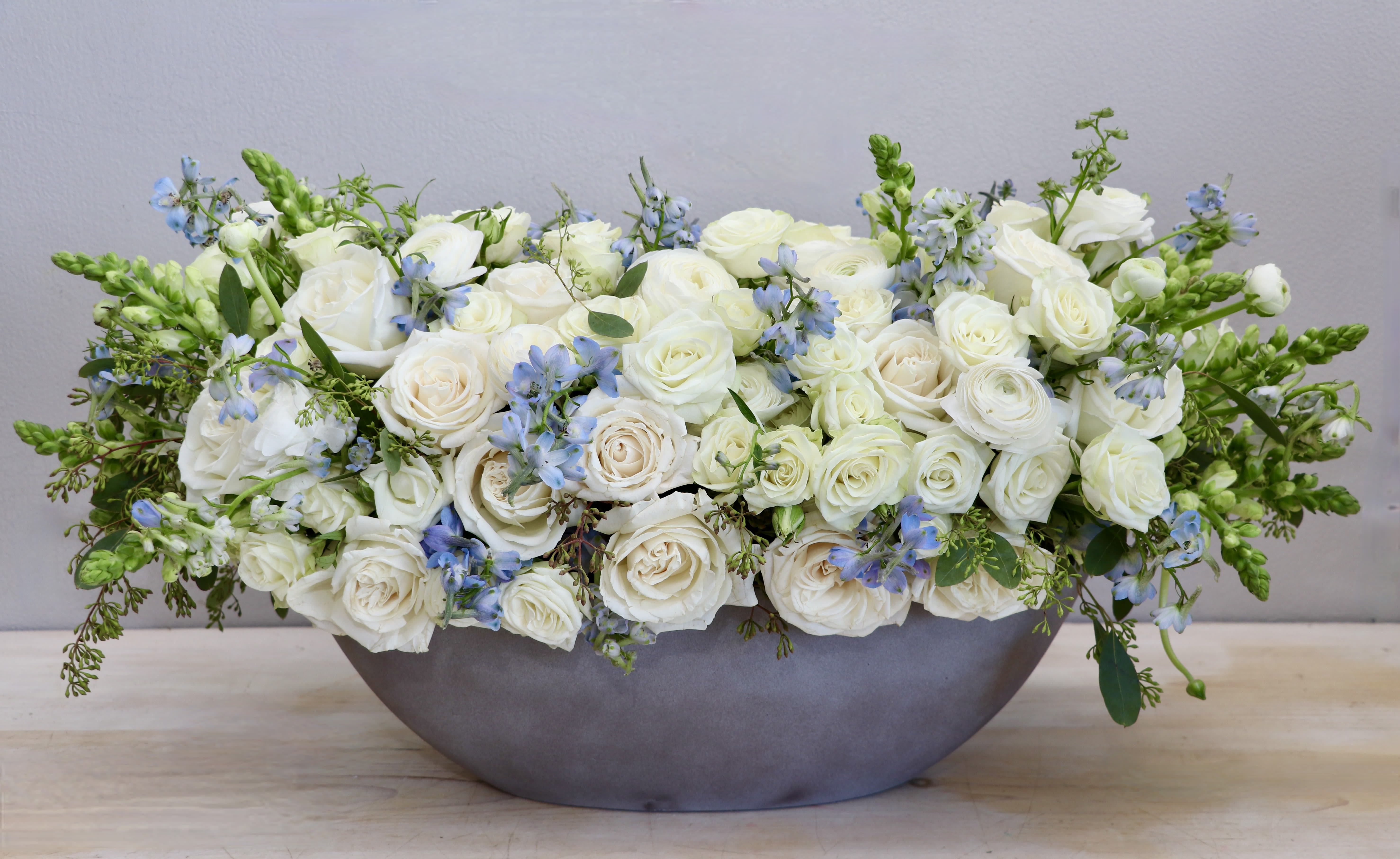Head in the Clouds - My Glendale Florist  - Roses, delphiniums, snapdragons and seasonal greens are elegently designed in our large oval ceramic container. This arrangements is approxiamtely 30 '' long and 15'' tall in standard size. 
