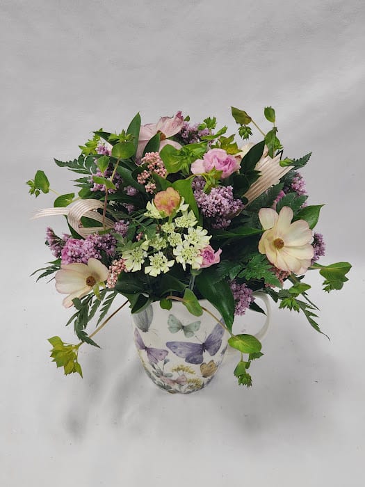 Butterfly Fields - Select this 360° whimsical arrangement featuring ranunculus, carnations and rice flower in a keepsake butterfly mug.   Approximately 9" x 8" x 8"