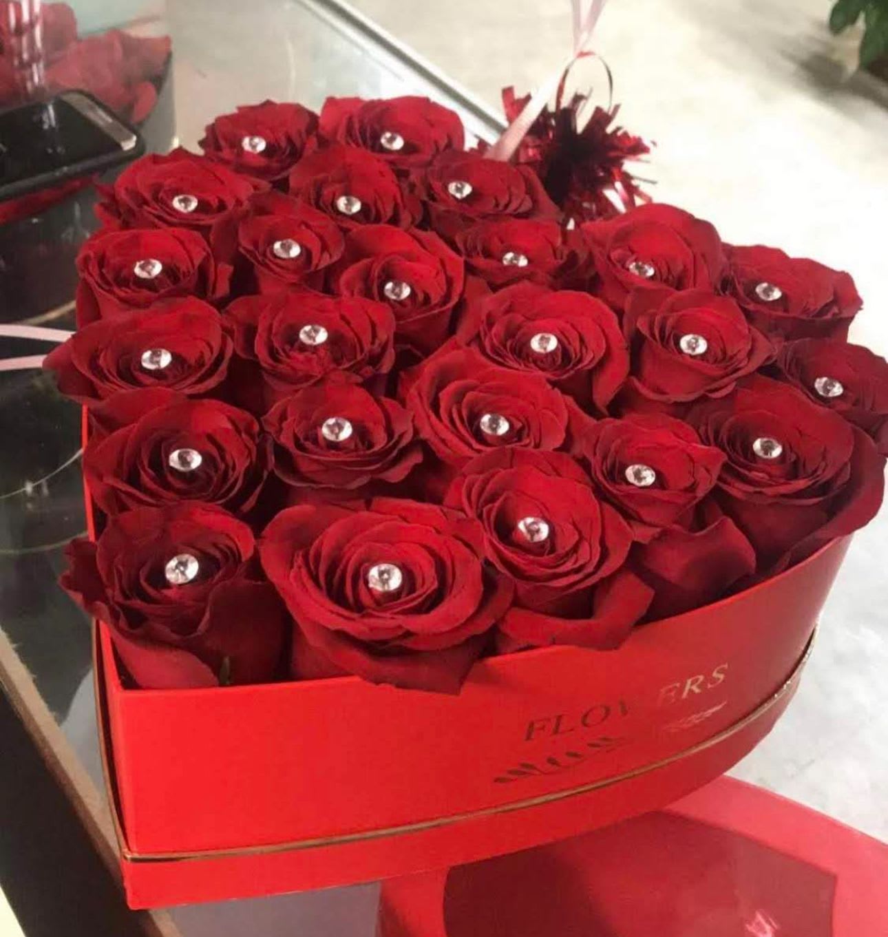 Roses In Heart Shaped Red / Black Boxes.  - A Heart Shaped box complete with velvety roses immaculately arranged. Packaged in a timeless and sophisticated style. A perfect complement to any celebration. 