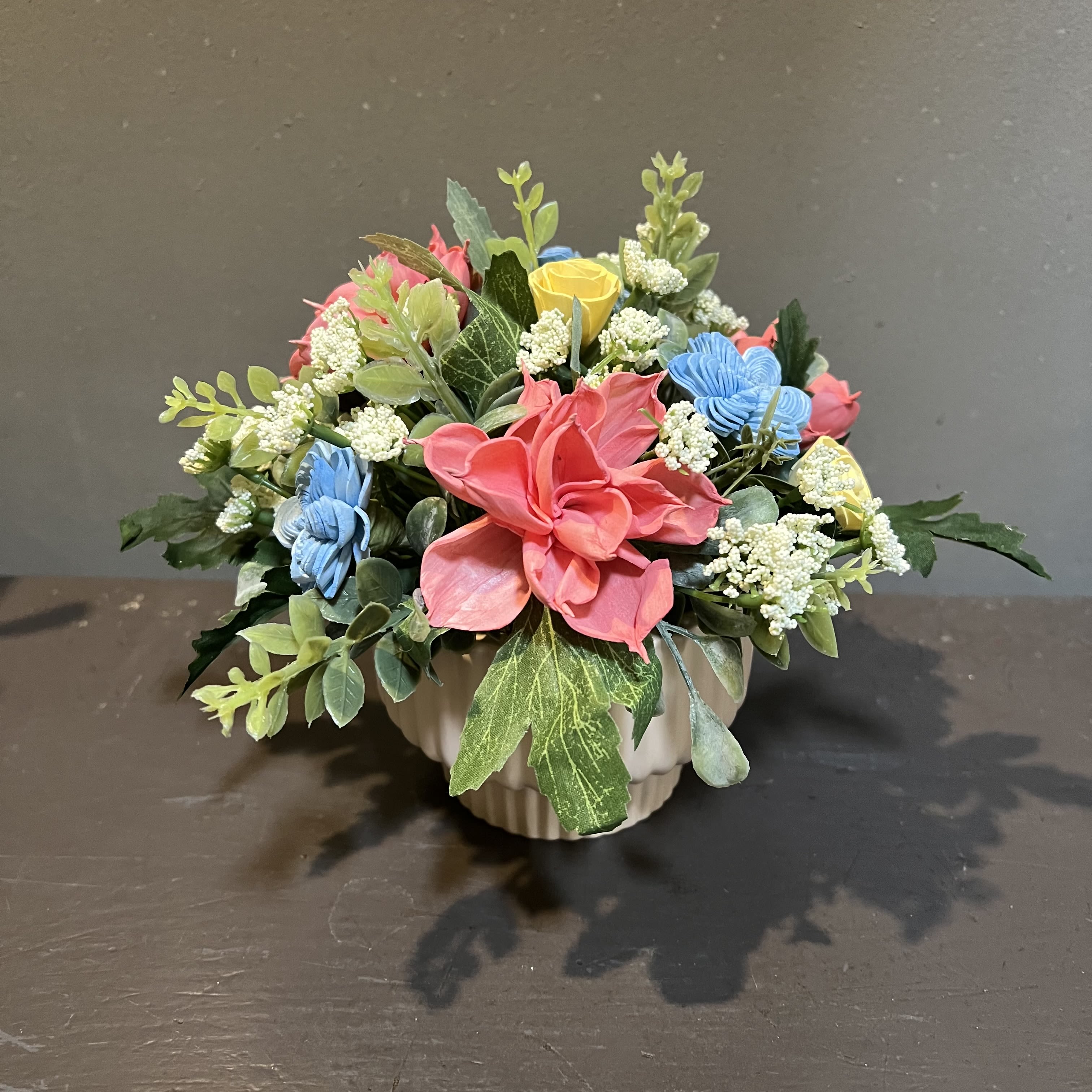 Sola Wooden Flower Centerpiece - Precious Petals - Hand-dyed and hand-crafted in Minneapolis, these flowers made of balsa wood are a wonderful everlasting floral arrangement - great for those with allergies! Can be used as a natural essential oil diffuser too! Arrives in a ceramic vase. Approx. Dimensions: 8"Tx9"W