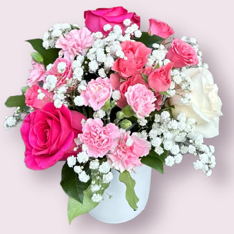 Parvati's Blossoming Serenity #23 - "Parvati's Blossoming Serenity" is an exquisite flower arrangement named in honor of Parvati, the Hindu goddess of love, devotion, and divine beauty. This arrangement elegantly combines: Pink roses, symbolizing love and admiration. Perla roses, adding an air of grace and elegance. Peach spray roses, representing warmth and devotion. Pink mini-carnations, evoking charm and affection. Gypsophila (baby's breath), providing an ethereal and delicate ambiance. "Parvati's Blossoming Serenity" captures the essence of the goddess's serene and divine beauty. It's the perfect gift to convey love, devotion, and a sense of inner peace.