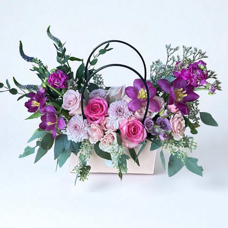 Flower Arrangement In A Bag Designer's Choice #60 - Experience the beauty of personalized floral artistry with our Designer's Choice Flower Arrangement in a Bag. Each arrangement is a unique creation, tailored to your preferences and crafted with the freshest blooms of the season. Our expert florists will contact you to discuss your preferred flower choices and color palette, ensuring that your arrangement perfectly matches your vision.  Presented in a chic, stylish bag, this arrangement is perfect for any occasion, whether it’s a birthday, anniversary, or just to brighten someone's day. Trust our designers to blend creativity and elegance, delivering a floral masterpiece that will delight and impress. Order now for a bespoke floral experience that’s as unique as you are.