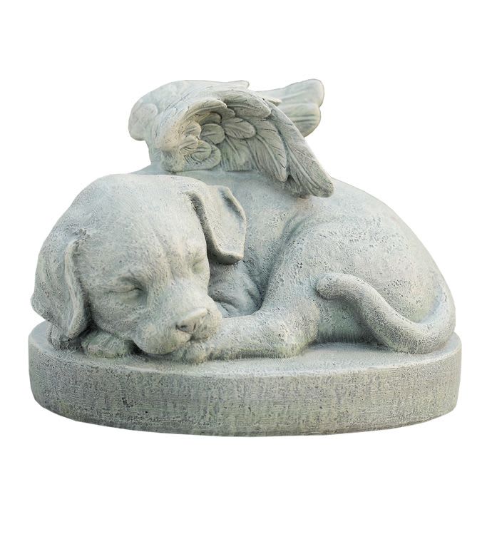Sympathy Dog Figure - A tender sculpted stone puppy curled in peaceful sleep makes this sympathy arrangement a gentle way to honor a beloved pet. The stone dog figurine with delicate angel wings feels protective and calm, offering a heartfelt focal point for a pet memorial or remembrance display. Carved in a pale gray, lightly weathered stone, the sleeping pup rests on a round base with a soft, timeless texture that suits indoor mantels or a sheltered garden spot. The small, angelic wings arch over the puppy's back, creating a comforting silhouette that reads as both delicate and durable.  Place this piece beside a photo, floral tribute, or on a keepsake table to give the person you're thinking of a quiet, lasting reminder of companionship and love. Its modest size makes it easy to tuck into existing memorial arrangements; no special care is required beyond occasional dusting.