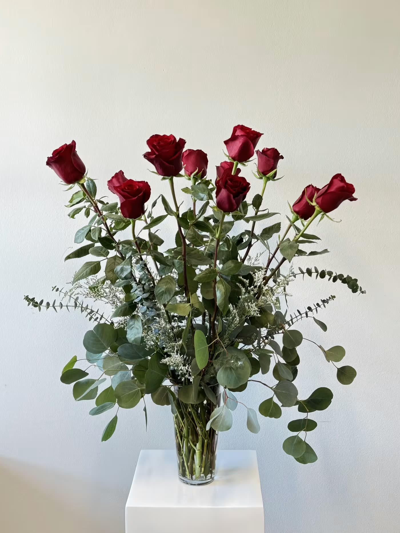 Long Red Roses - Indulge in timeless romance with the Super Long Stemmed Red Roses bouquet, featuring premium red roses with extraordinary 32-inch stems for dramatic height and elegance. These luxurious blooms symbolize passionate love and devotion, enhanced by lush varieties of eucalyptus greenery and filler that add texture, fragrance, and a sophisticated touch.  Choose your perfect size: Standard ($110): One dozen breathtaking long-stemmed red roses Deluxe ($210): Two dozen for twice the wow factor Premium ($310): Three dozen for an unforgettable grand gesture  Ideal for Valentine's Day roses, anniversary flowers, romantic apologies, proposal surprises, or simply to say "I love you," this extra long stem red roses arrangement creates a stunning focal point in any room. The tall stems allow for impressive vase displays, while the aromatic eucalyptus complements the velvety red petals perfectly. Hand-selected for superior quality and freshness, our long stemmed red roses with eucalyptus are a classic yet elevated choice. Searching for dozen red roses delivery, luxury two dozen roses, three dozen red roses bouquet, or 32-inch tall rose arrangements? Order today for same-day or next-day delivery—arrives beautifully wrapped with care instructions to maximize vase life. Make hearts skip a beat with this iconic symbol of enduring love!