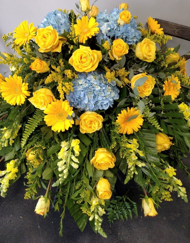 Ocean Sunset - This casket piece floral can be created as a full or a half saddle. Like a sunset over the ocean this beautiful floral makes you feel calm and warm.