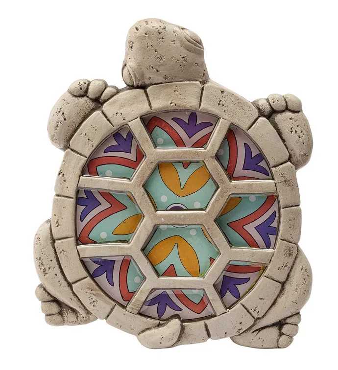 Mosaic Turtle Steppingstone - A cheerful mosaic turtle steppingstone that brightens a garden, patio, or entryway - perfect as a casual gift or small housewarming surprise. This mixed-color decorative stone reads like a miniature sculpture with a weathered, textured body and a shell inlaid with hexagonal mosaic tiles in teal, orange, purple, red, and white dots, making it a playful accent for everyday outdoor living. The compact, turtle-shaped form balances neutral stone tones with vivid geometric color, so it stands out among greenery or on a porch without overwhelming the space. Its sturdy, textured finish gives a handcrafted look and feels durable enough for outdoor display; place it on soil, a planter rim, or a flagstone path to add a splash of color and whimsy.  Give this as a thoughtful pick-me-up for a friend who loves garden art, a child who delights in animal decor, or anyone needing a small cheerful accent - the kind of gift that makes someone smile every time they see it. Care is simple: wipe clean with a damp cloth and avoid prolonged exposure to standing water to preserve the mosaic inlay. 11.5 Inches by 9.25 Inches