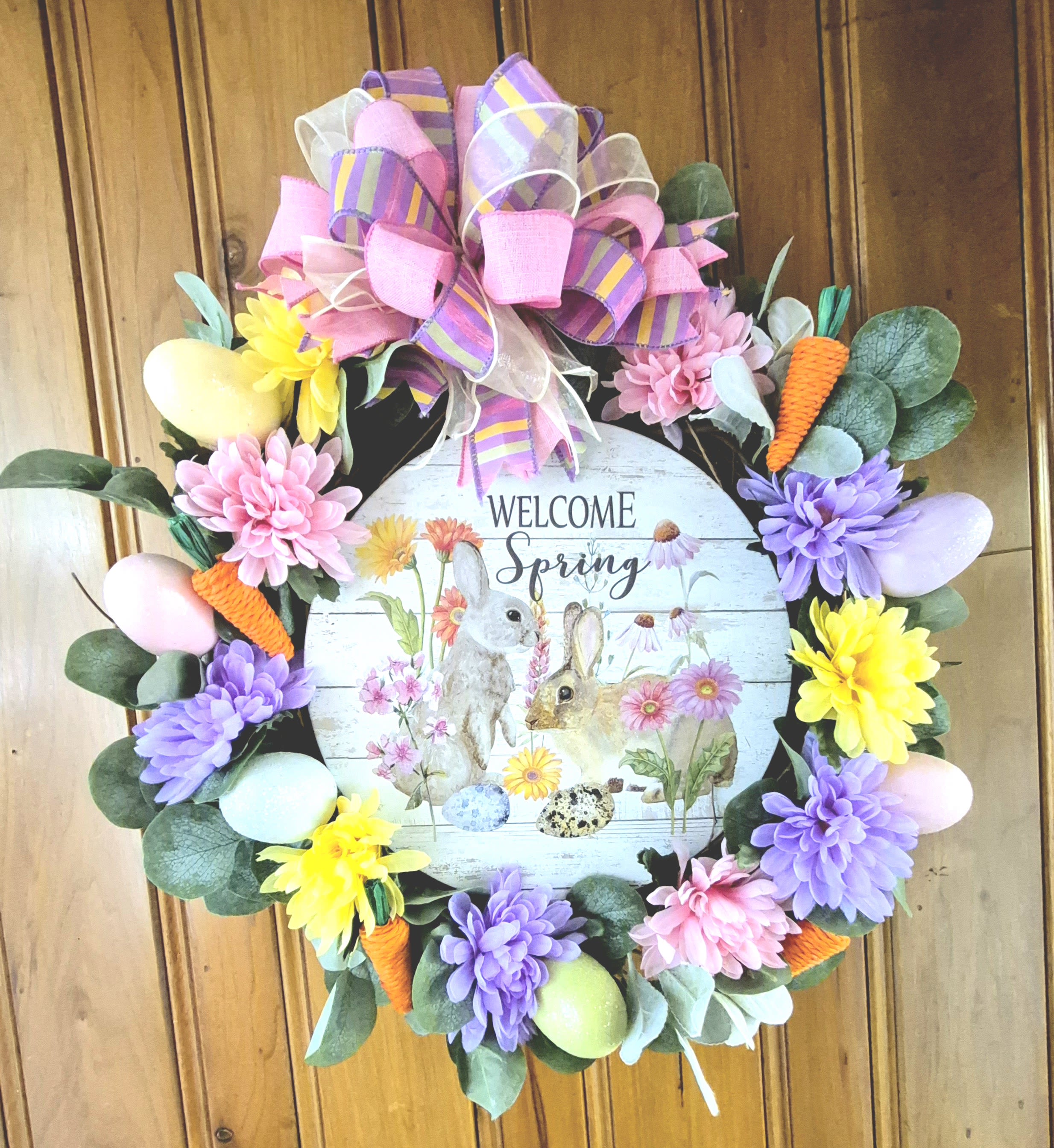 "Welcome Spring" Silk Wreath - Welcome family and friends to your home this Spring with this beautiful wreath for your front door. This Welcome Spring wreath is sure to make a statement on your front door this Spring or send as a gift. 22" Tall 20" Wide 