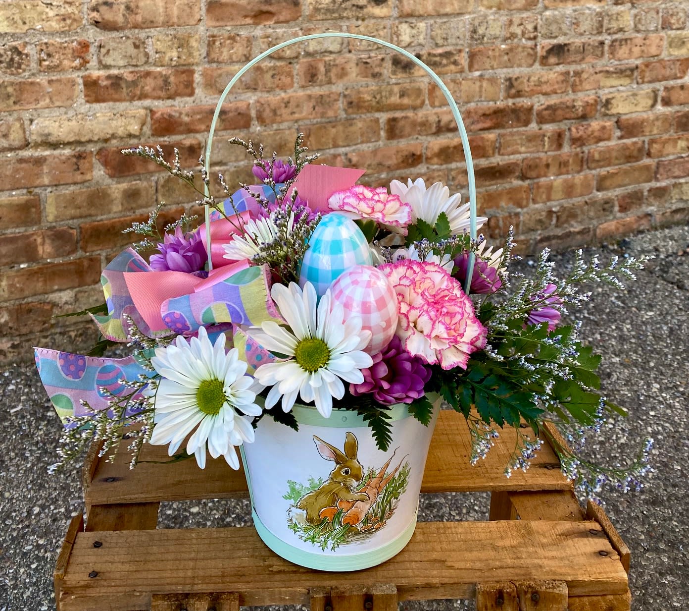 Easter Basket - An adorable arrangement for Easter. An assortment of flowers in a cute bunny basket. The colors of the basket and flowers may vary.  We are proud to deliver our flower creations to the Kenosha, Somers, and Pleasant Prairie area. With over 55 years of combined flower design experience in Kenosha, Wisconsin, A Summer's Garden Florist and Gifts is the perfect choice for the freshest flowers, most creative design and exceptional customer service.