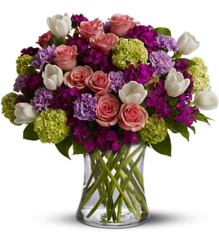 Spring Time in Paris - Does someone you love dream in French? Do they hum "Springtime in Paris" in the shower? Then this romantic gift is sure to make their fancies take flight. Roses, tulips, carnations and more - in the prettiest hues of pink, purple, white and green - create a beautiful all-around bouquet.    A mix of fresh flowers such as roses, tulips, carnations and viburnum â in shades of green, pink, white and lavender â are arranged in a glass vase. Approximately 14" (W) x 19" (H) 