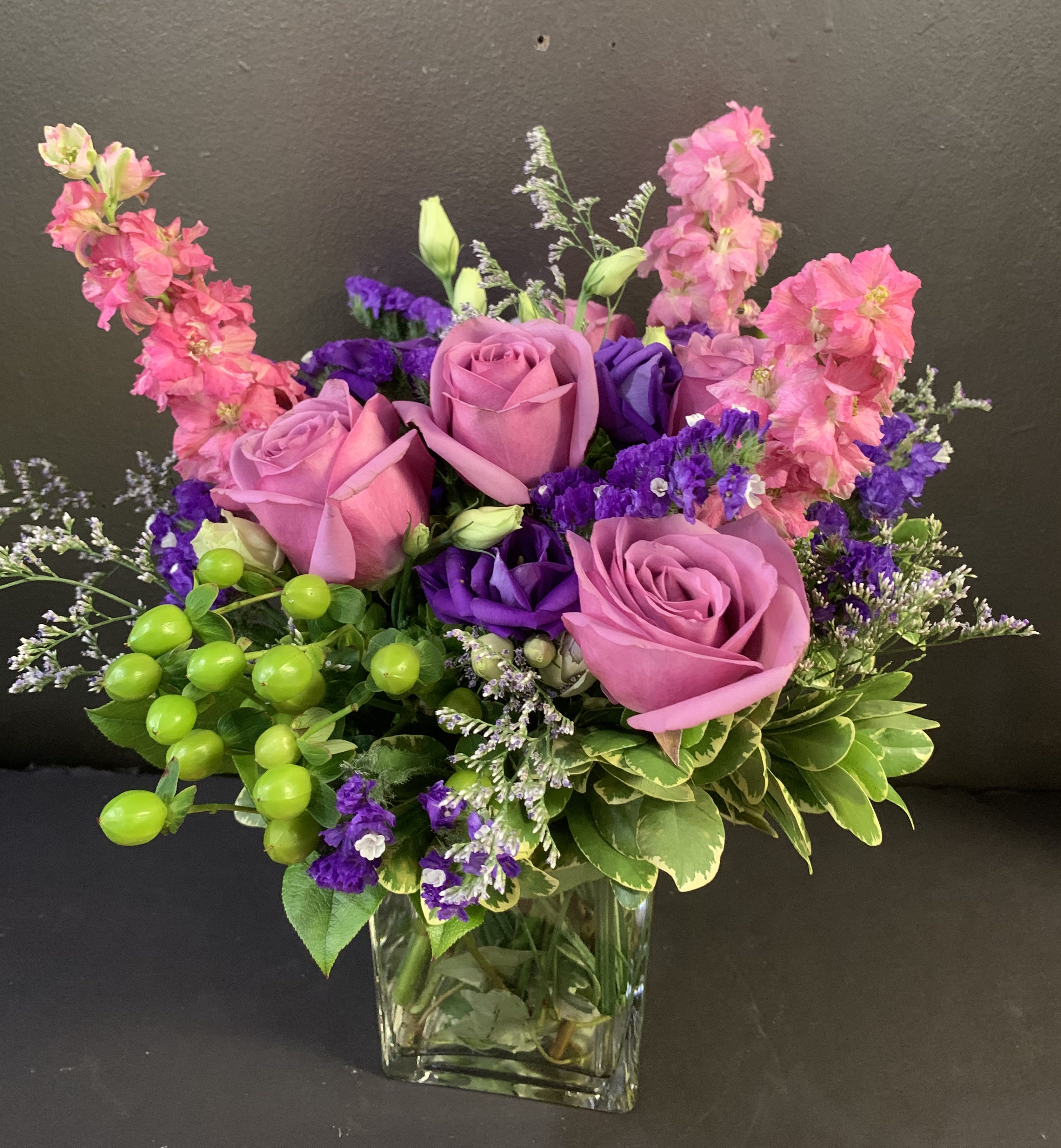 Spring Fling  - This arrangement includes pink roses, green hydrangea, purple statice. Spring Fling is a great gift for a birthday, get well, or just because.  Exact flowers included may be substituted due to market availability but color and feel will stay the same. 