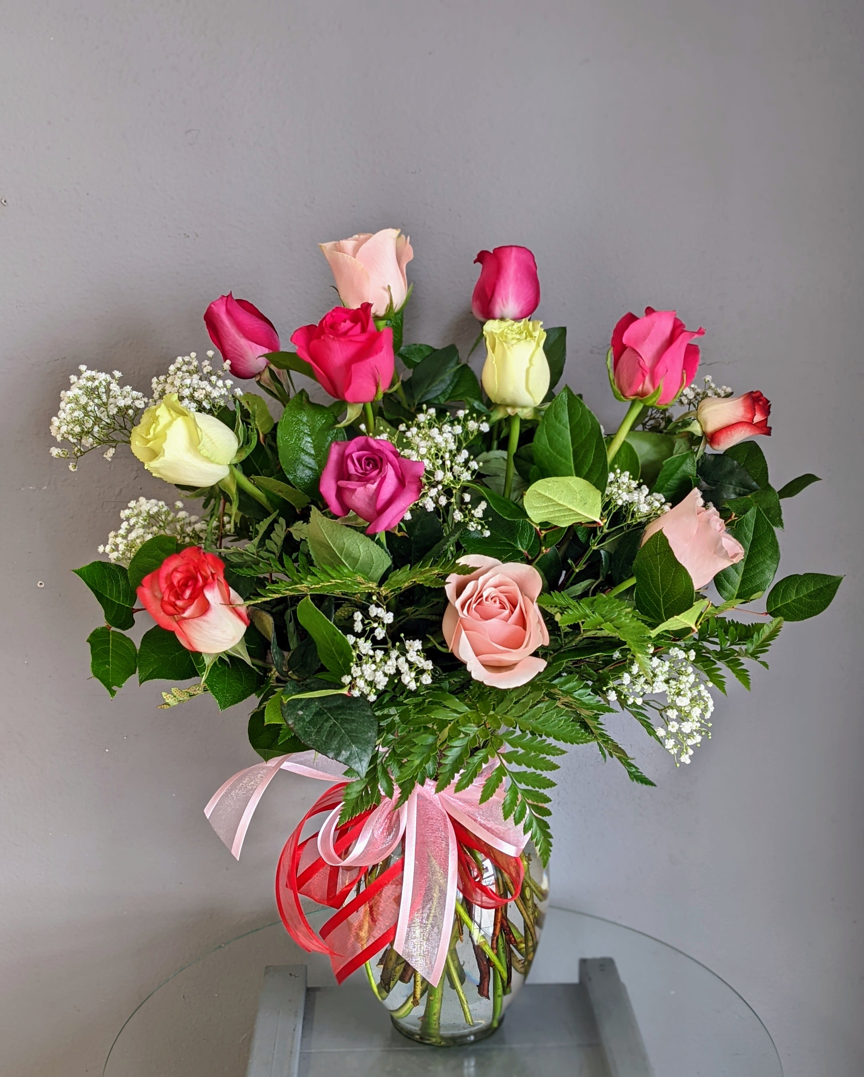 1 Dozen Mixed Colored Roses - A classic, ravishing arrangement of MIXED colored roses. Comes in a vase with filler and greens.  Colors, filler and greens WILL vary.  ***PLEASE NOTE*** * Bloomsnaps and timed delivery are not available during Valentine's Day (2/12-2/14) * *** Please be flexible. Based on quality and/or availability, Substitutions of equal or greater value may be made at the designer’s discretion (including flowers, greens, filler, vase and hard goods) without notice