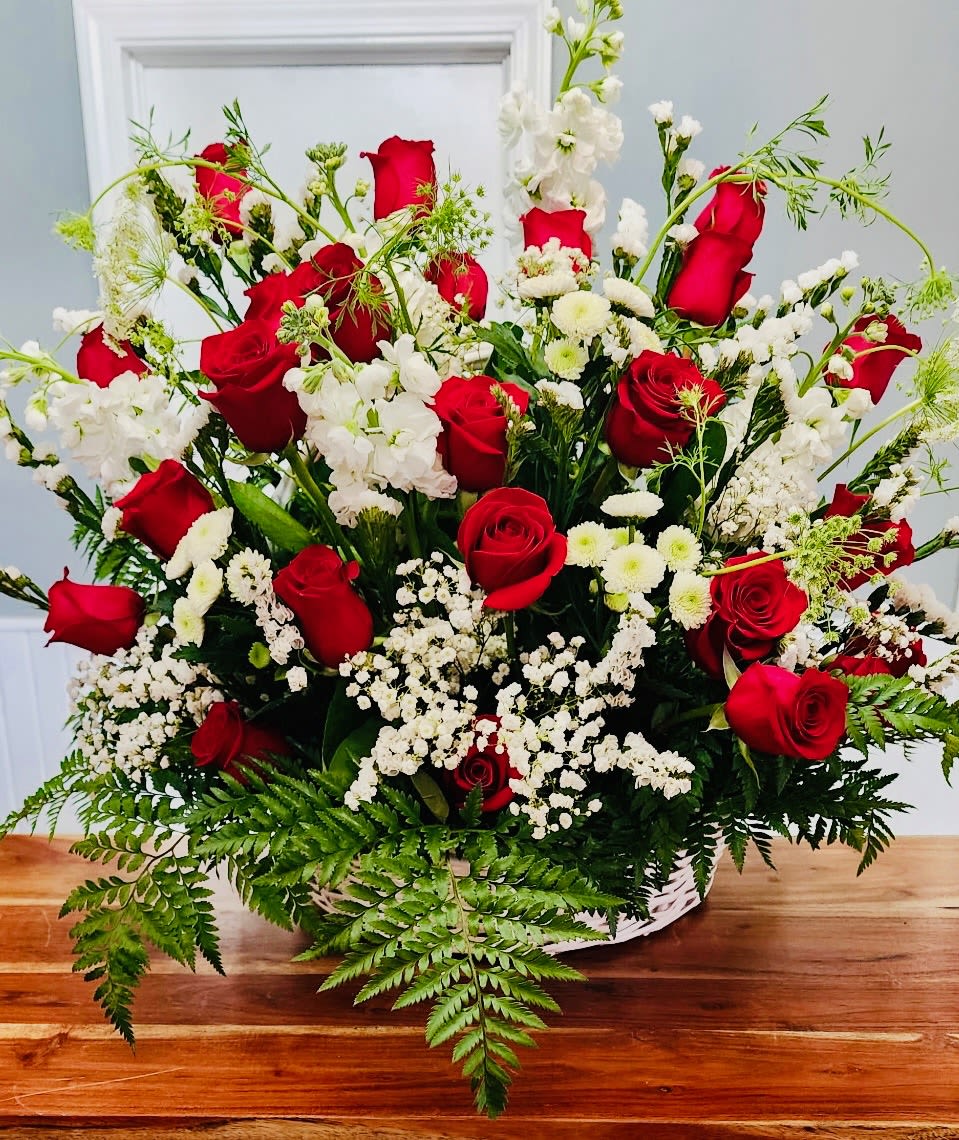 Forever in our heart - Vivid red roses with white flowers and luxurious greenery in a basket.