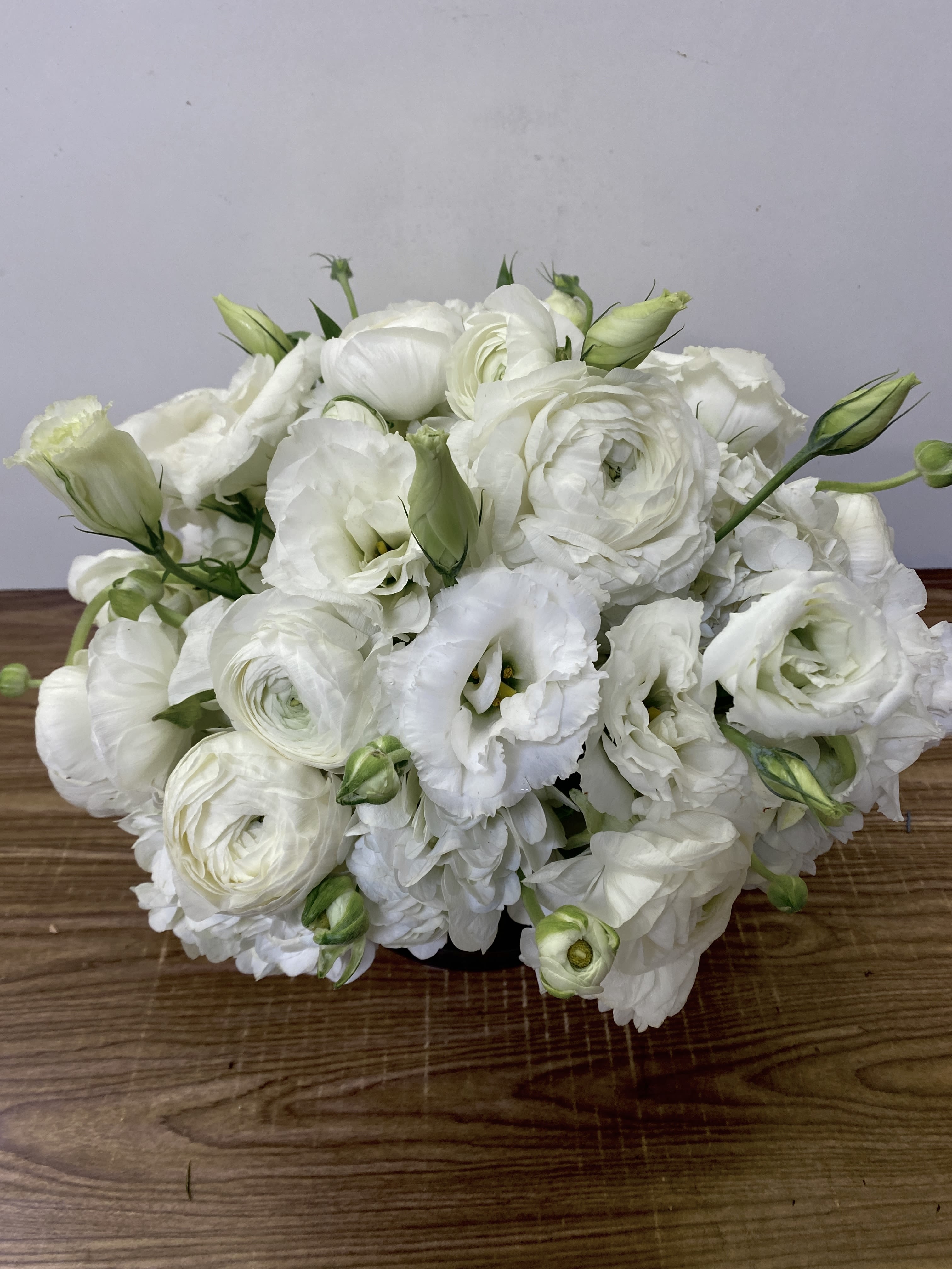 HAPPY ENDING - HAPPY ENDING | Jane's Roses Pure Elegance from Your San Francisco Florist Celebrate life’s most beautiful conclusions and new beginnings with HAPPY ENDING, a breathtakingly serene arrangement by Jane's Roses. As a premier San Francisco Florist, we specialize in artisanal designs that convey deep emotion through floral artistry. This monochromatic masterpiece is the ultimate expression of purity, grace, and sophisticated luxury, making it an ideal choice for weddings, anniversaries, or a peaceful addition to a modern home.  A Symphony of White Blooms The HAPPY ENDING design is a lush, dense collection of the finest white seasonal flowers:  Premium White Ranunculus: These exquisite blooms, known for their paper-thin, delicate layers, provide a soft and romantic texture.  Crisp White Lisianthus: With their elegant, rose-like ruffles and verdant buds, these flowers add depth and a touch of garden-fresh whimsy.  Lush White Hydrangea: Serving as a voluminous base, these cloud-like clusters ensure the arrangement feels full and opulent.  Modern Sophistication Designed with a low-profile, "Biedermeier" style, this compact mound of white blossoms is perfectly suited for a dining table or a sleek office desk. When you need a San Francisco Florist that understands the power of understated elegance, trust Jane's Roses to deliver a gift that truly represents a "Happy Ending".