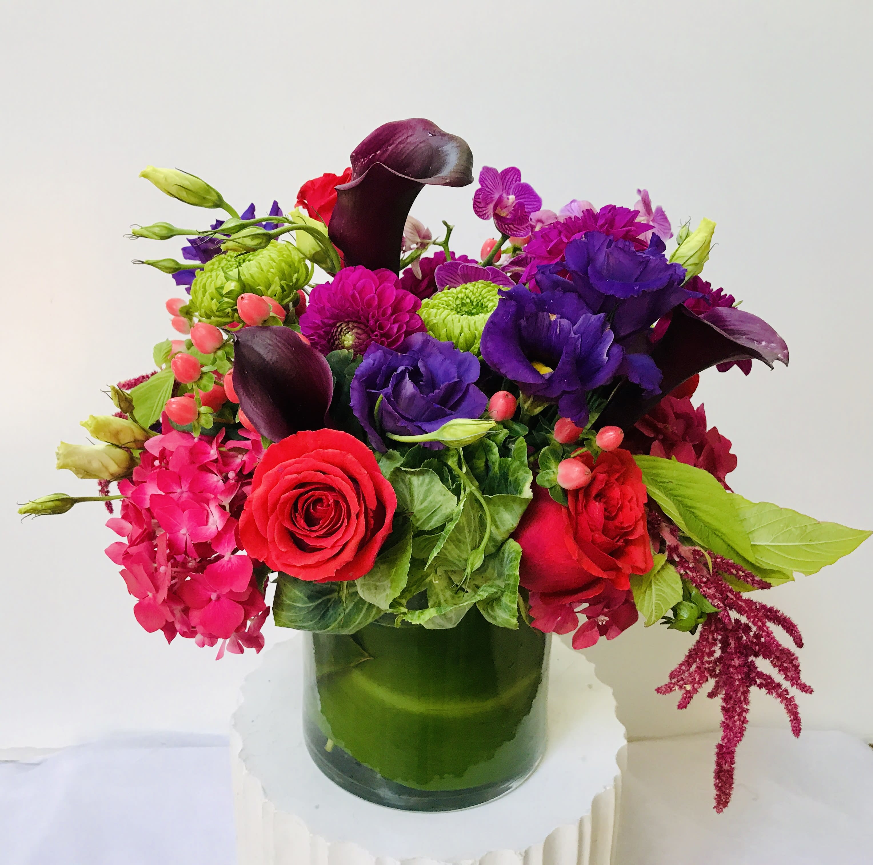 The Crown - mix of  burgundy, purple, dark pink flowers in a glass vase, arranged and will be delivered by Jane"s Roses of San Francisco