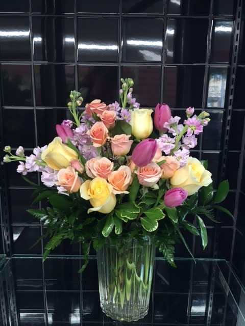 Pastel Mix in a Clear Glass Vase - A gorgeous mix of pastel colored flowers hand-crafted and designed in a clear glass vase. Roses and tulips in soft shades of pastel compliment one another to make the perfect mix! Great for every occasion!