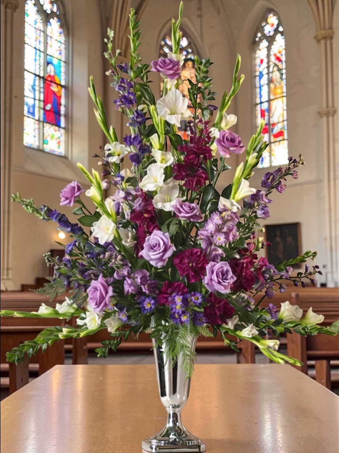Church Altar Arrangement - Ministry: Fresh altar arrangements designed to complement your service with balance, intention, and a clean, finished look. Each piece is created using seasonal flowers and styled to suit your space—never oversized, never underdone—just appropriate, polished, and thoughtfully placed.  Whether for weekly worship, Easter, Passover, holidays, or special services, these designs are built to work within the setting, supporting the altar without distracting from it. The goal is simple: create something that feels right the moment you walk into the room.  Each arrangement is uniquely created with the freshest stems available, with color and flower selection varying slightly to ensure the best overall presentation. Special instructions or preferences can be added prior to checkout.  Available for local delivery through Aspen Tower Florist, serving Shelbyville and Greensburg along with Rushville, Batesville, Westport, Oldenburg, St. Paul, Waldron, and Milroy.