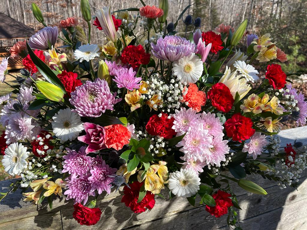 "Tranquil Repose" Arrangement - A soothing and elegant symphony of nature's most beautiful blooms, artfully crafted to grace the casket and honor a life cherished. This exquisite floral tribute is a heartfelt way to celebrate a life well-lived and offer comfort to those who mourn. 