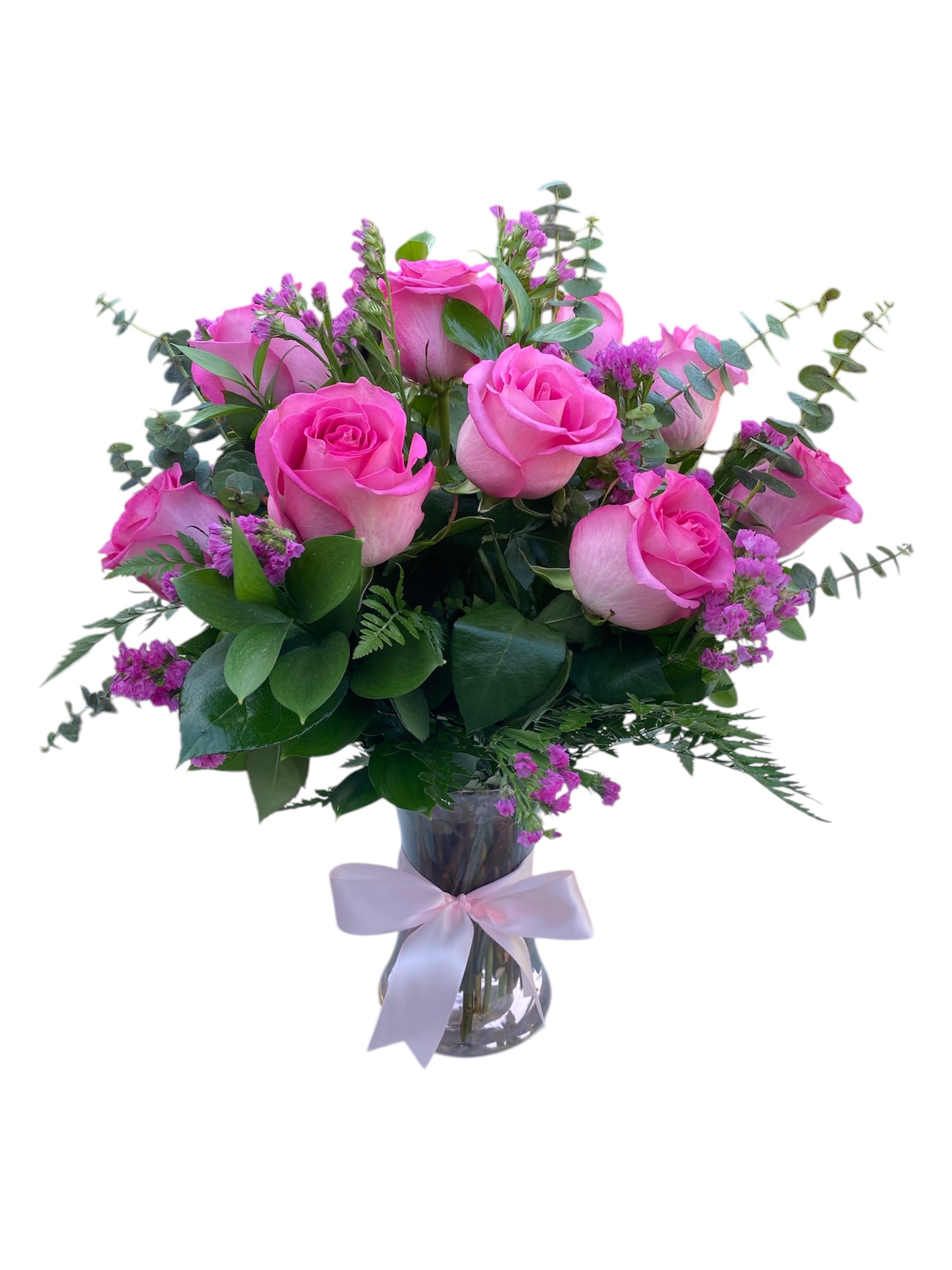 Pink Perfection - Twelve pink/hot pink roses arranged with greens and fillers in a glass vase.