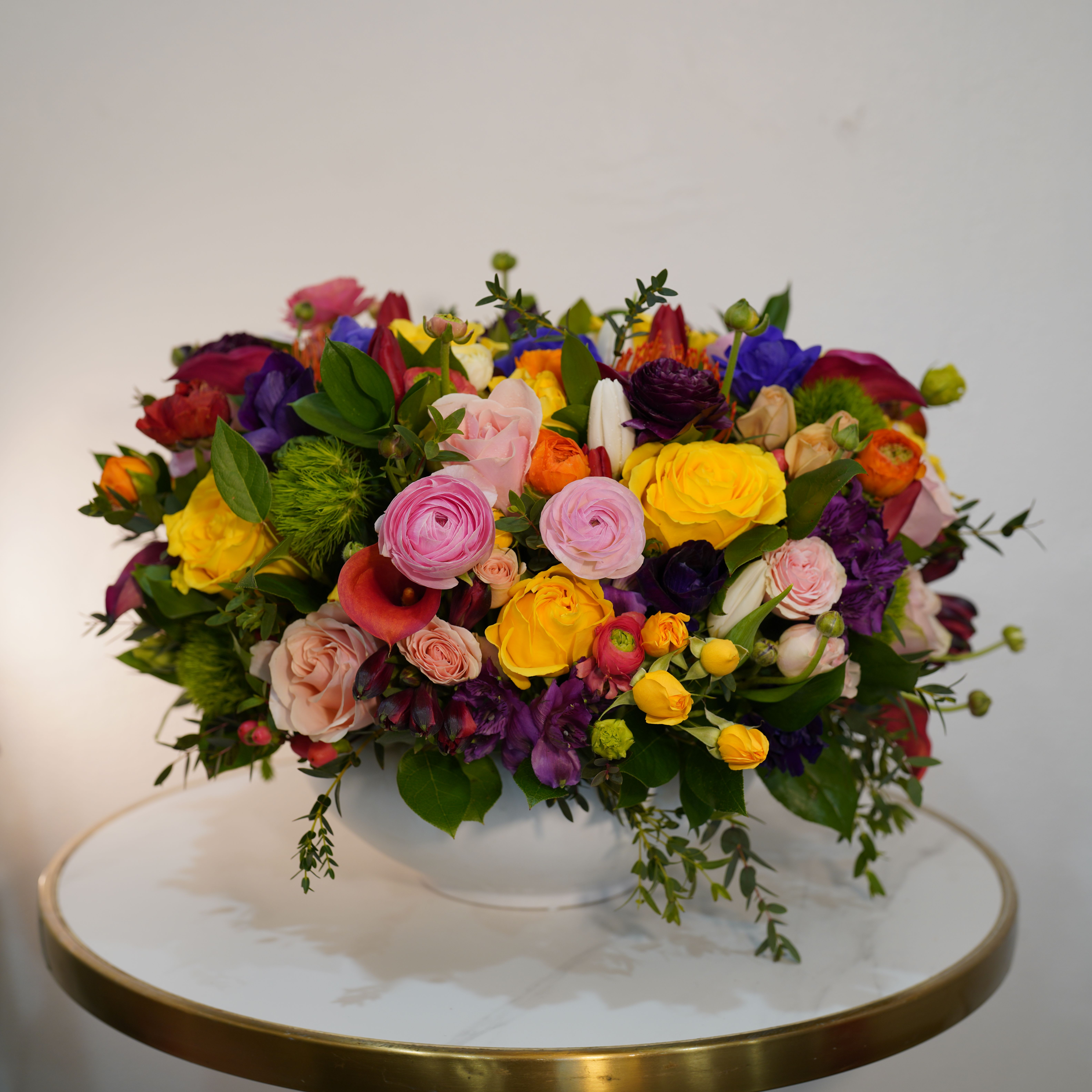 Color Pop - Bold, vibrant, and full of energy — our Color Pop  arrangement is designed to make a statement. Featuring a stunning mix of bright seasonal blooms in vivid shades of pink, yellow, orange, purple, and green, this arrangement brings life and excitement into any space. The rich variety of textures and colors creates a playful yet stylish design that instantly grabs attention. Perfect for birthdays, celebrations, congratulations, or simply to brighten someone’s day, this arrangement delivers happiness in every detail. Each piece is handcrafted by Guy Floral Studio using the freshest flowers available, ensuring a unique and premium look every time. Same-day flower delivery available in Beverly Hills, West Hollywood, Santa Monica, Beverly Grove, Bel Air, Culver City, and surrounding Los Angeles areas. The arrangement shown in the photo reflects our Deluxe size, featuring a fuller, more abundant design with premium blooms.