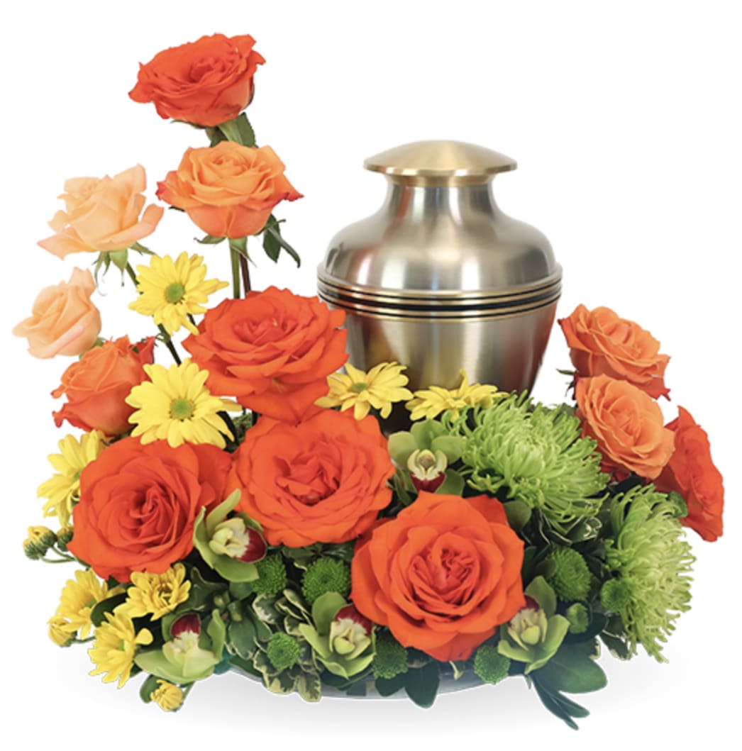 Setting Sun Urn Wreath - Setting Sun Urn Wreath | Wilmington, Delaware Florist  Honor a vibrant spirit with our Setting Sun Urn Wreath, a radiant floral tribute handcrafted by Petals Flowers and Fine Gifts in Wilmington, Delaware. This striking design surrounds the urn with rich sunset-inspired hues—featuring bold orange roses, peach roses, cymbidium orchids, and touches of yellow and green accents, thoughtfully arranged to reflect a life full of warmth and energy. Wreath measures 12" in diameter.  Perfect for memorial services or cremation ceremonies, Setting Sun is a meaningful expression of admiration and celebration. Its vivid color palette serves as a reminder of the brightness your loved one brought to the world and the enduring light they leave behind.  As your trusted local florist in Wilmington, Delaware, we create every arrangement with premium blooms and genuine care. We offer same-day, tax-free delivery throughout Wilmington, Hockessin, Newark, Chadds Ford, Glen Mills, Kennett Square, and nearby communities.  * Not available for same-day delivery.  Why Choose Us?  * Custom, luxury floral designs with a satisfaction guarantee * Locally owned flower shop in North Wilmington, Delaware * Friendly, personal service with delivery to your loved ones’ doorsteps Order the Setting Sun Urn Wreath to celebrate a bold, beautiful life and offer a tribute throughout Wilmington and surrounding areas.