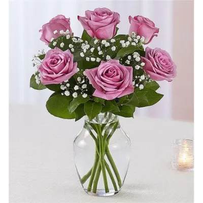 6 Lavender Roses Vased - Beautifully arranged by our skilled designers with lush greenery inside an elegant glass vase, six blooms are delivered right to the door to delight them for a special celebration or an out-of-the blue surprise.