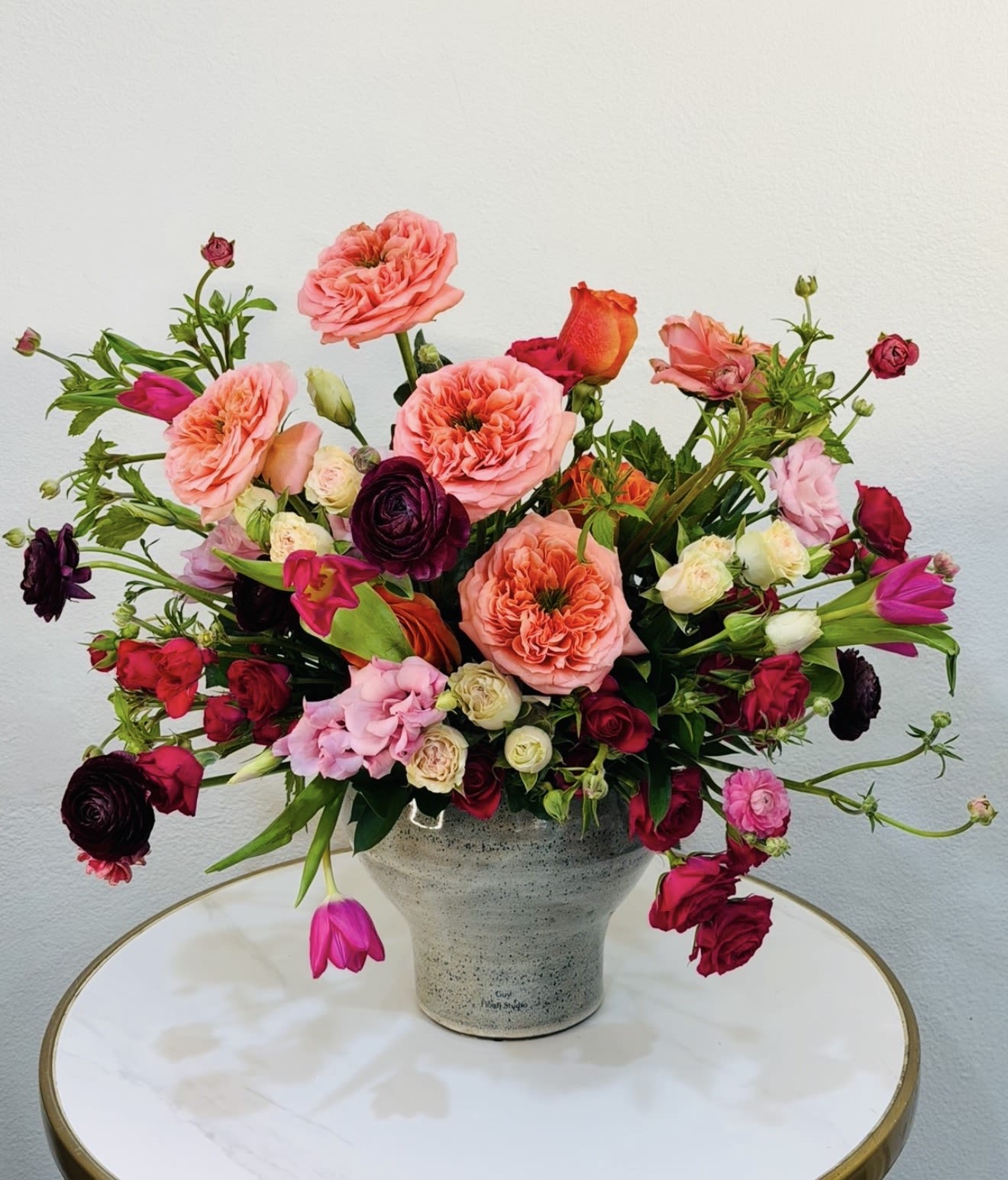 Blush Bloom Garden - Introducing Blush Bloom Garden, a refined designer floral arrangement that blends soft blush tones with vibrant pops of color for a fresh and luxurious look. This elegant composition features premium seasonal blooms including garden roses, ranunculus, tulips, and delicate accent flowers, all thoughtfully arranged in a modern ceramic vase. Perfect for celebrations, gifts, or elevating any space, this arrangement brings a sophisticated yet joyful presence. Each design is handcrafted at Guy Floral Studio with attention to detail and a passion for high-end floral artistry. Same-day flower delivery available in Beverly Hills, Bel Air, West Hollywood, Beverly Grove, Culver City, Hollywood Hills, Hollywood, Santa Monica, and surrounding Los Angeles areas. The arrangement shown in the photo reflects our Deluxe size, featuring a fuller and more abundant design with premium blooms.
