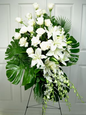 Heavens Light - A beautiful spray that gives a very elegant look that fills the room with light and love it is a wonderful piece for a loved one. with its stunning Dendrobium orchids and amazing white roses and precious white Lillys. This arrangement is sure to give light with its presents.  