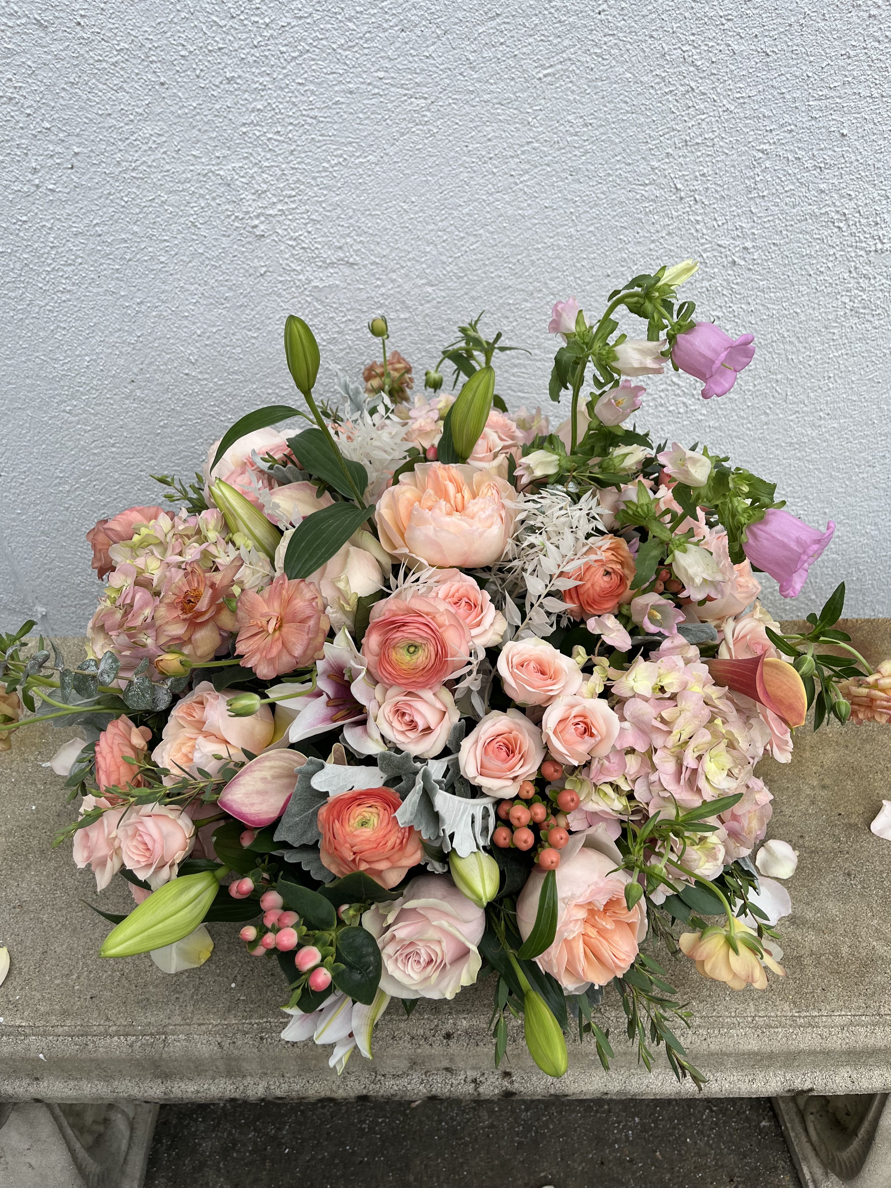 Tea Time - Tea Time is a stunning upscale arrangement including garden roses, calla lilies, ranunculus, hydrangea, berries and more in all shades of pink. Comes in a large white bowl.