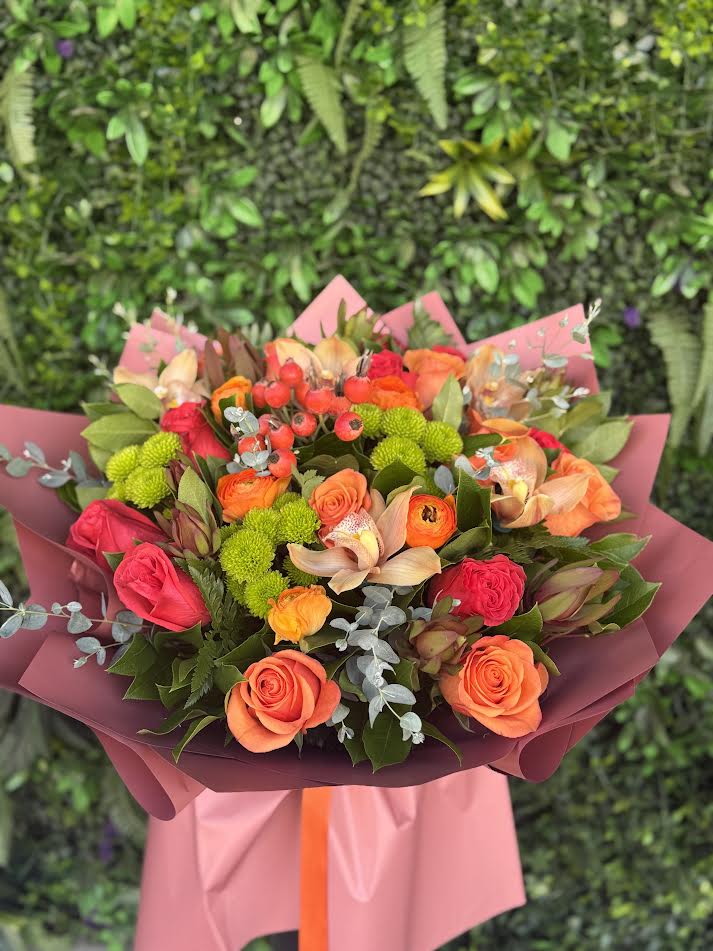 Paradise - A vibrant summer bouquet bursting with warm shades of orange, coral, and soft pink. Featuring a lively mix of roses, seasonal blooms, and fresh greenery, this bouquet radiates energy, joy, and sunshine. Perfect for brightening someone’s day or celebrating special moments with a touch of color and warmth.
