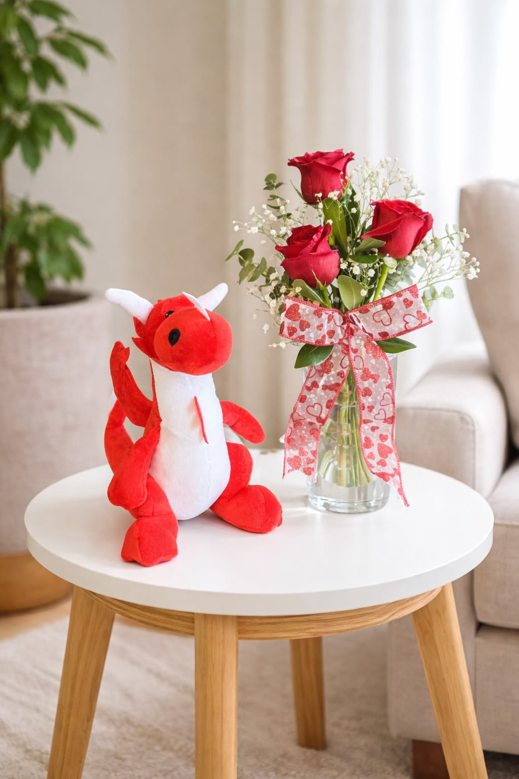 Bloom with Spike - Send a smile and a little blooming magic with Spike! This super cute red and white plush dragon, Spike, comes ready for adventure alongside a sweet vase of three red roses, fluffy baby's breath, and fresh greenery in a clear glass vase.  It's a fun and friendly gift for anniversaries, birthdays, recitals, or any day you want to say "You're Special!". 