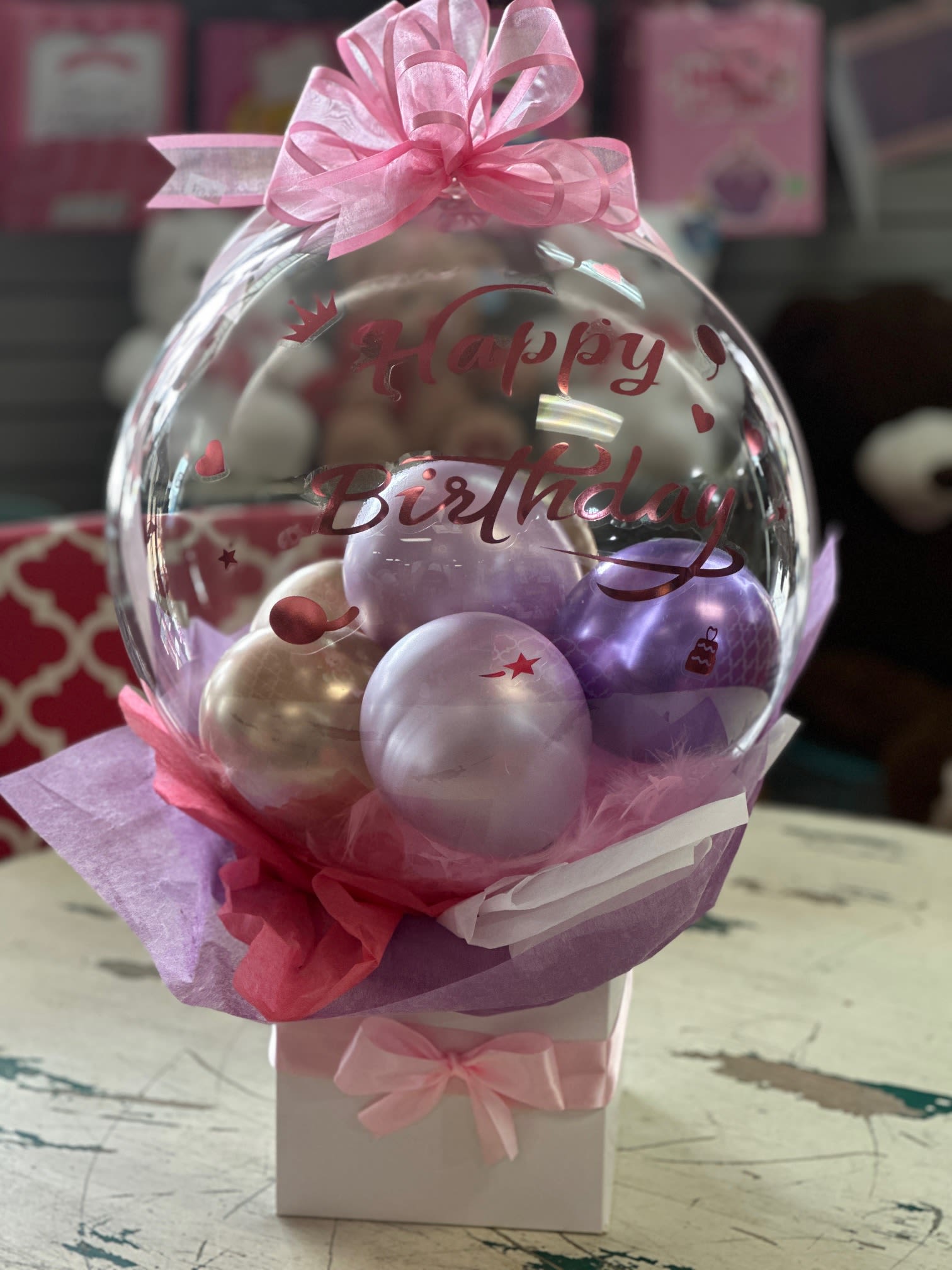 Birthday Bobo Balloon Gift Set - Make their birthday extra special with this adorable and unique balloon gift. This design features a handful of small balloons nestled inside a box with tissue paper. The Deluxe size includes a teddy bear. 