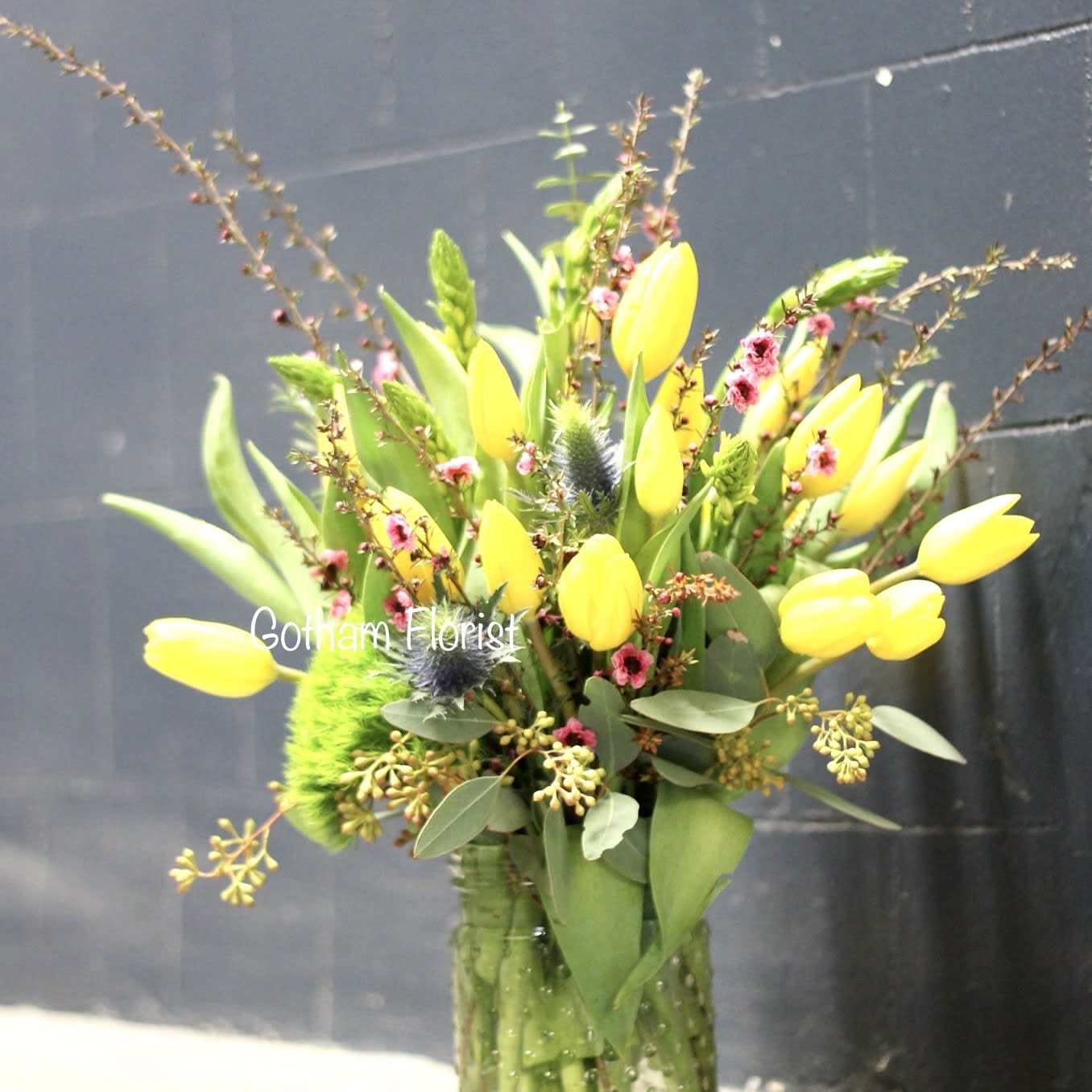 Ode to Spring - These cold winter days have us wishing for spring weather. Send these cheerful blooms to brighten up anyone's days. Pretty tulips in designers choice, arranged in hobnail vase with seasonal accents. Send the best flowers same day in nyc.