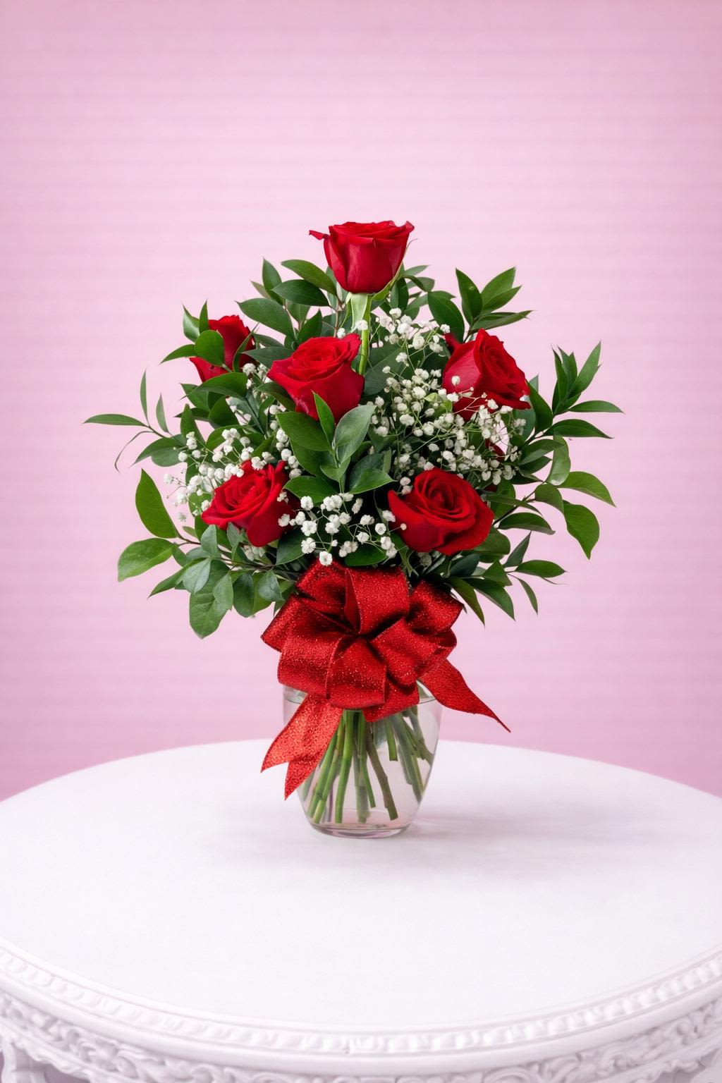 HALF DZ RED ROSES  - Classic red roses with baby’s breath and fresh greenery, arranged in a clear glass vase and finished with a red bow—perfect for expressing love and elegance.