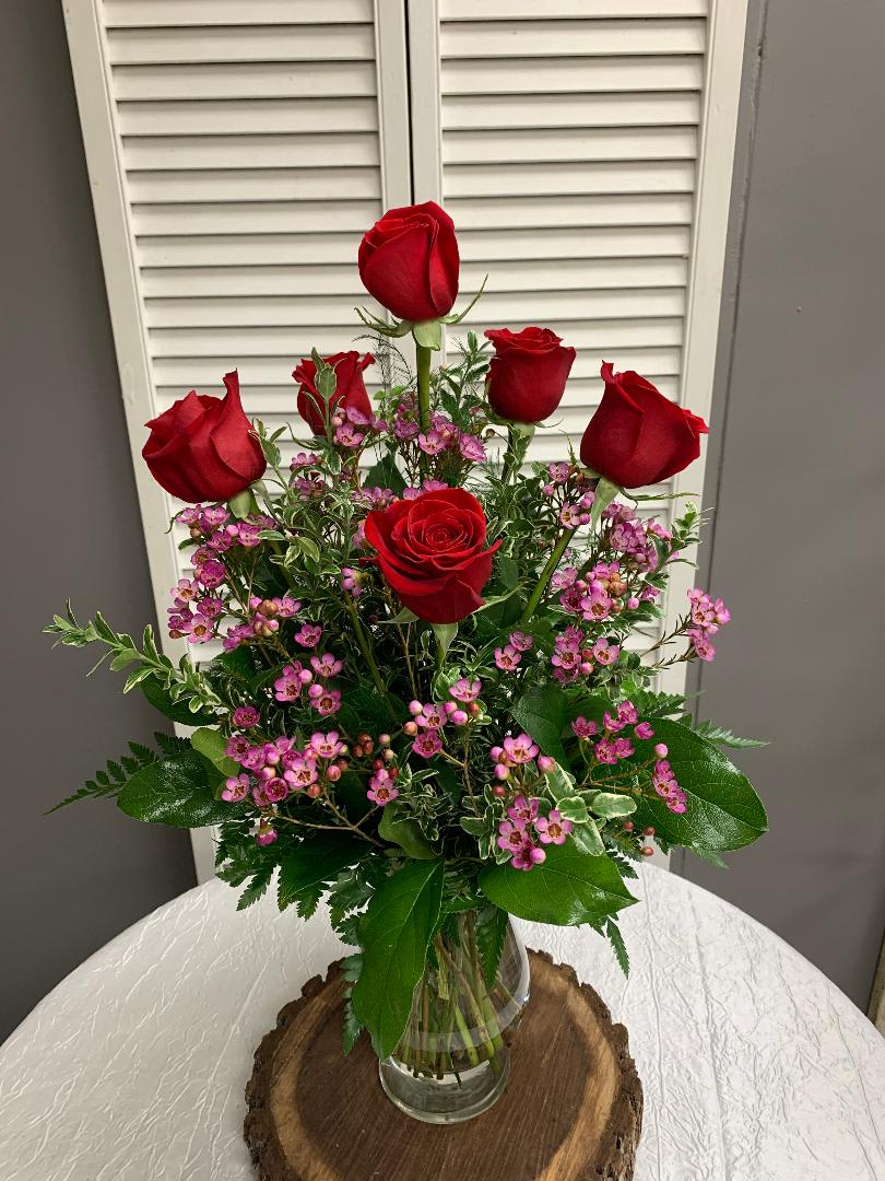 Half Dozen Rose Arrangement - A Classic Arrangement of Red Roses and Wax Flower. Other Color Roses are available.