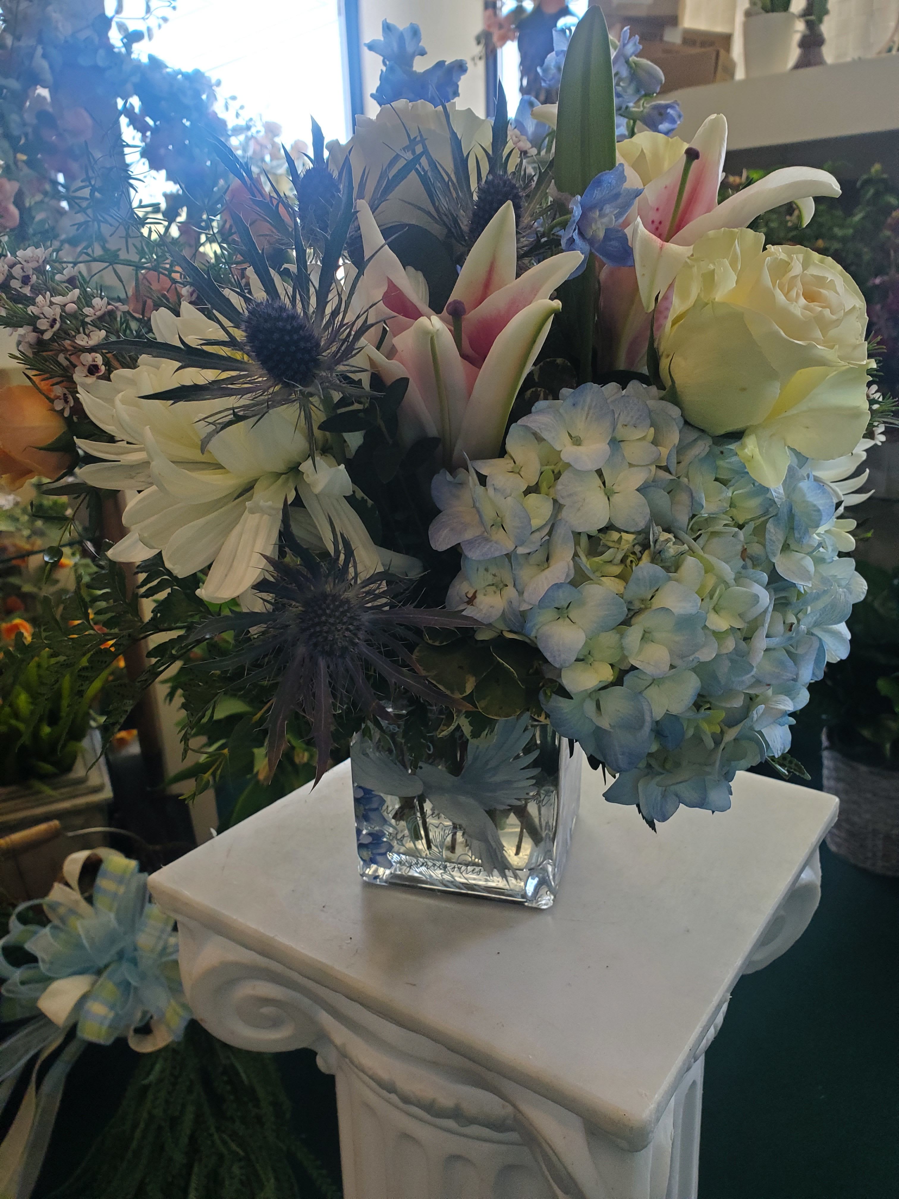 BLUE DAYDREAMS - KEEPSAKE CUBE FILLED WITH BLUE, WHITE &amp; PINK FLOWERS SUCH AS HYDRANGEA, LILYS, ROSES AND MIX