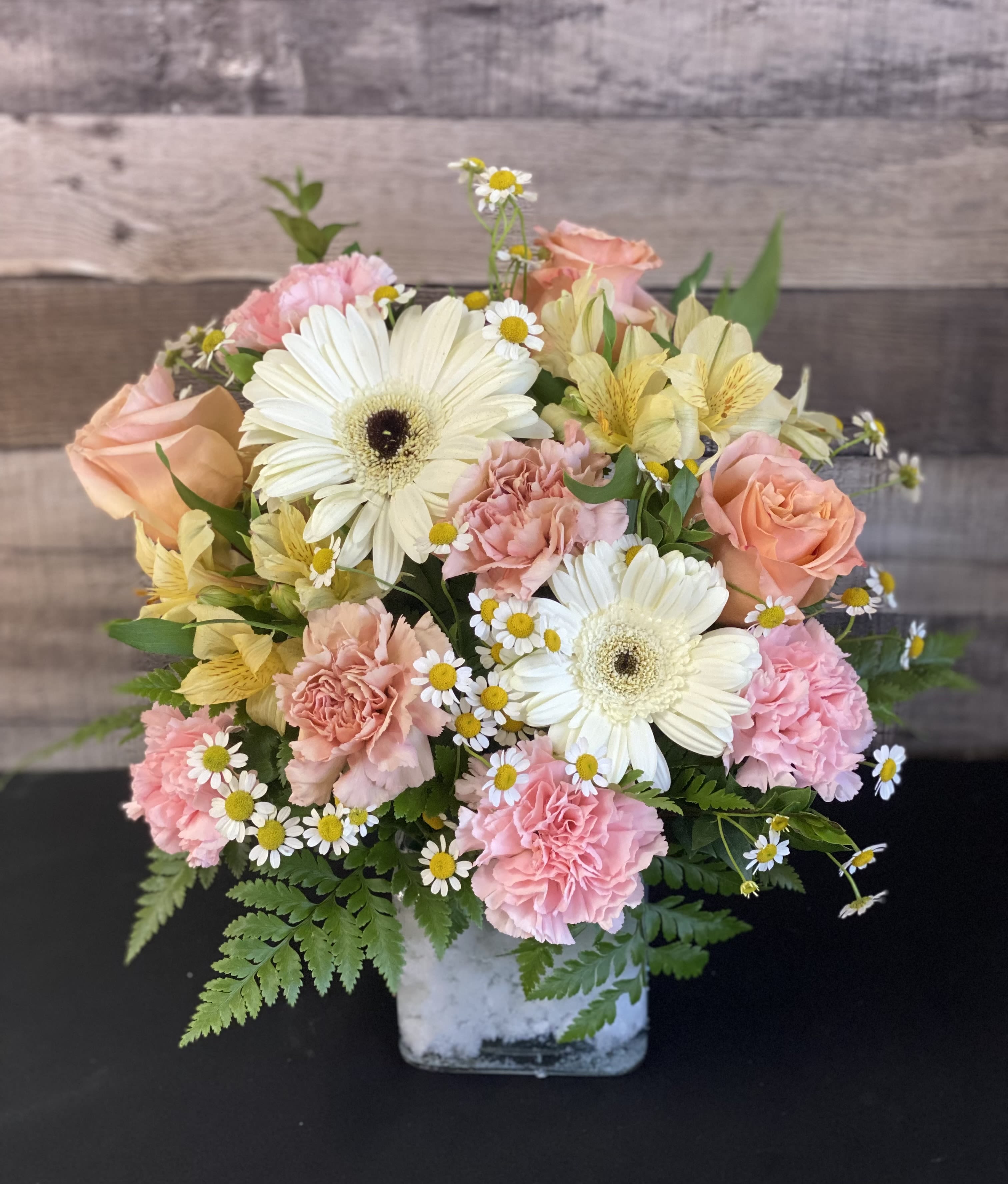Mixed bouquet in a square glass vase with pink and white flowers