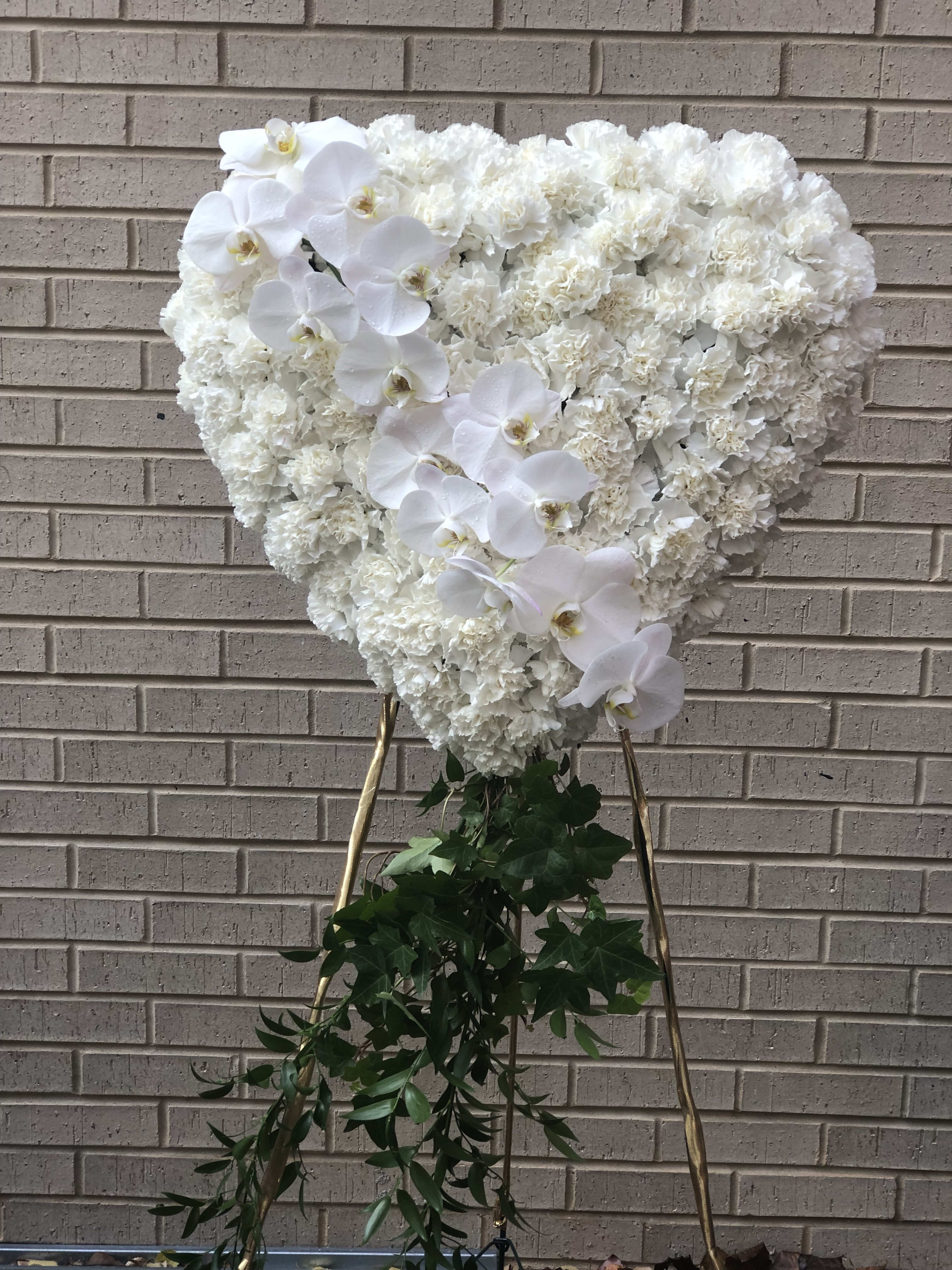All white Broken Heart - All white carnation base on the 24" heart with Phaleanopsis orchids segment comes with 60" easel. Please place your order in advance. Contact the shop for upgrades.