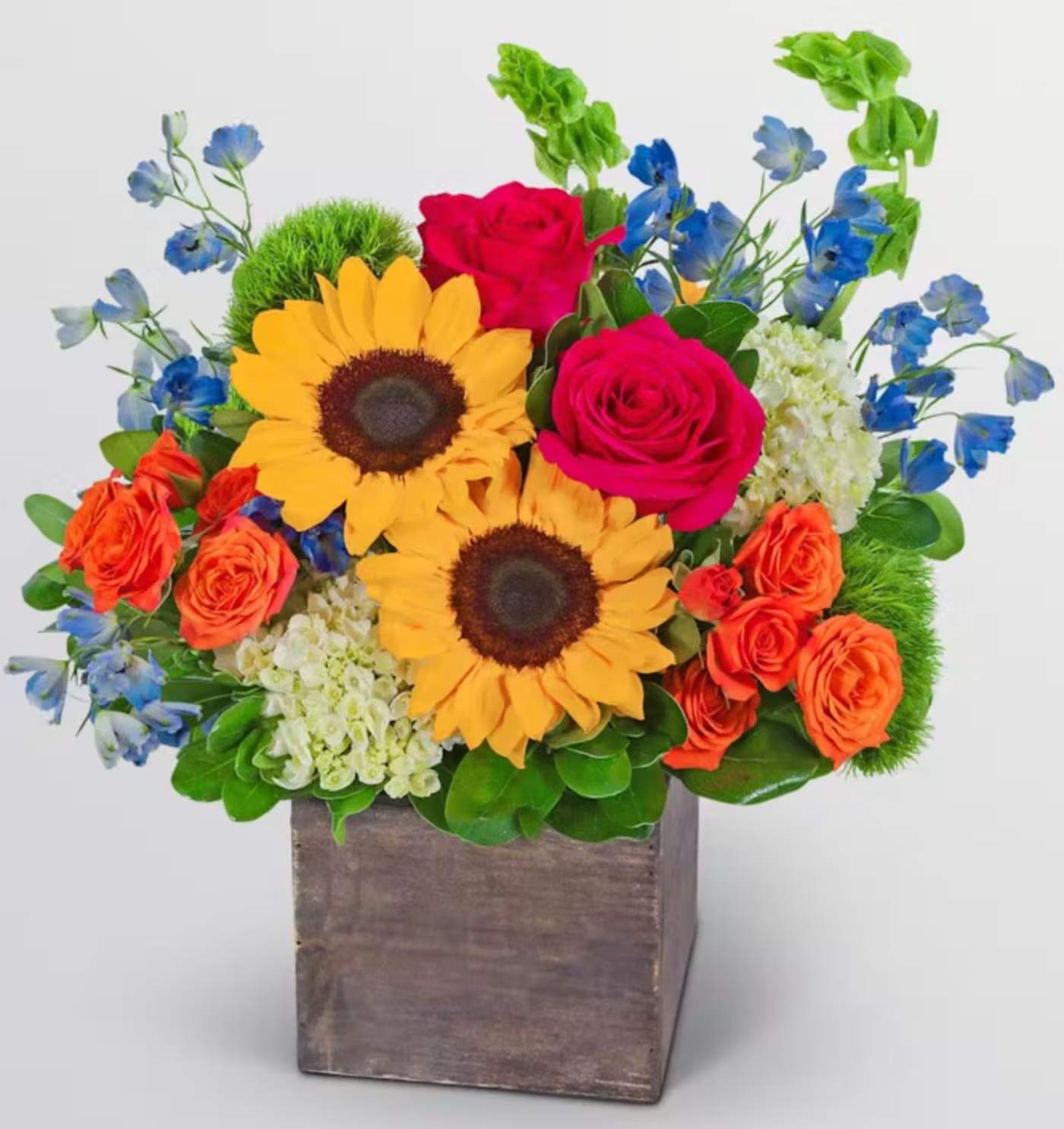 Sunny Bloom - A sunny burst of multicolor blooms such as sunflowers and roses in a wooden vase, perfect for brightening someone's day with a fresh burst of color.